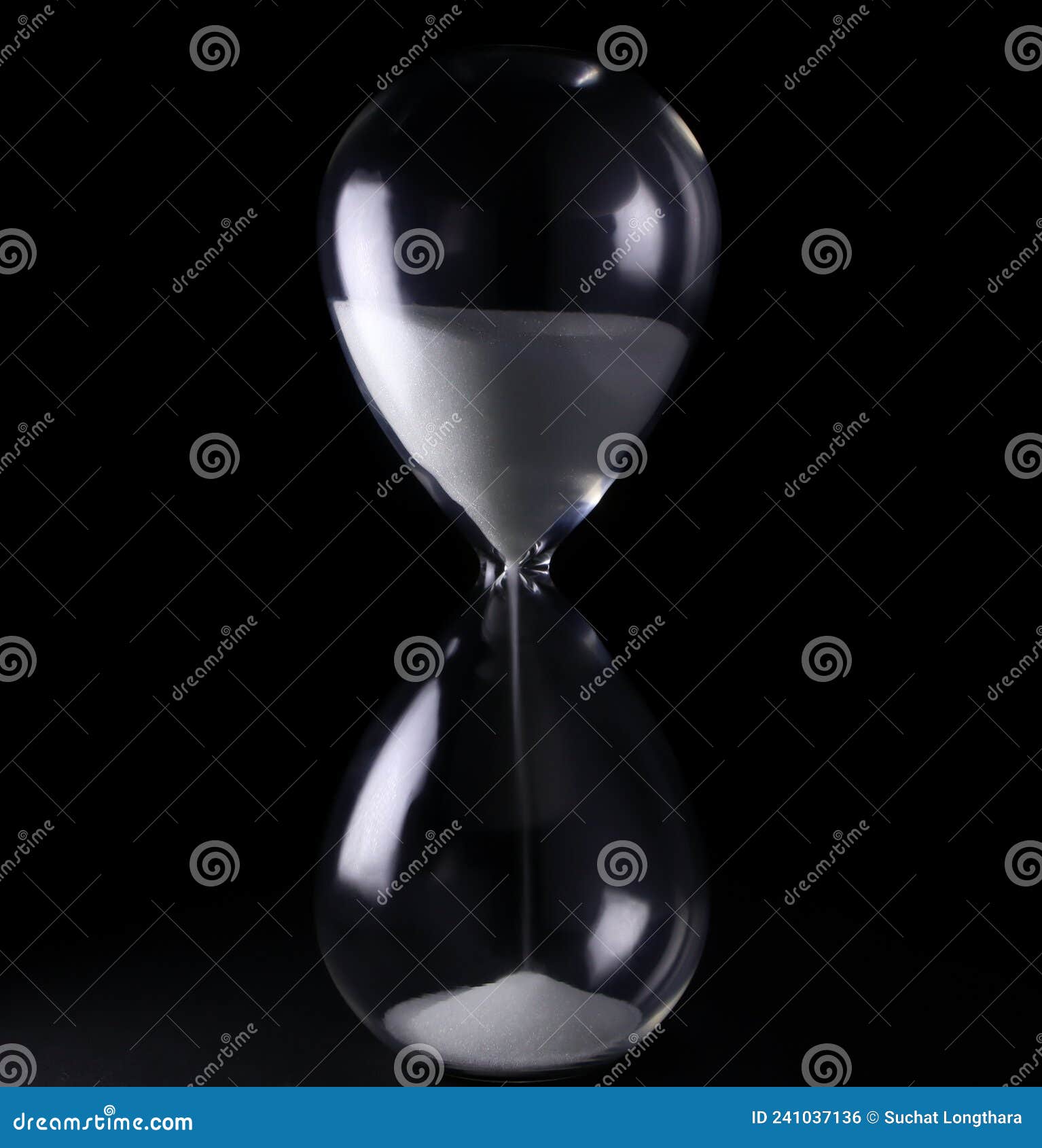 Hourglass with White Sand Showing Time from Low Light. Stock Photo