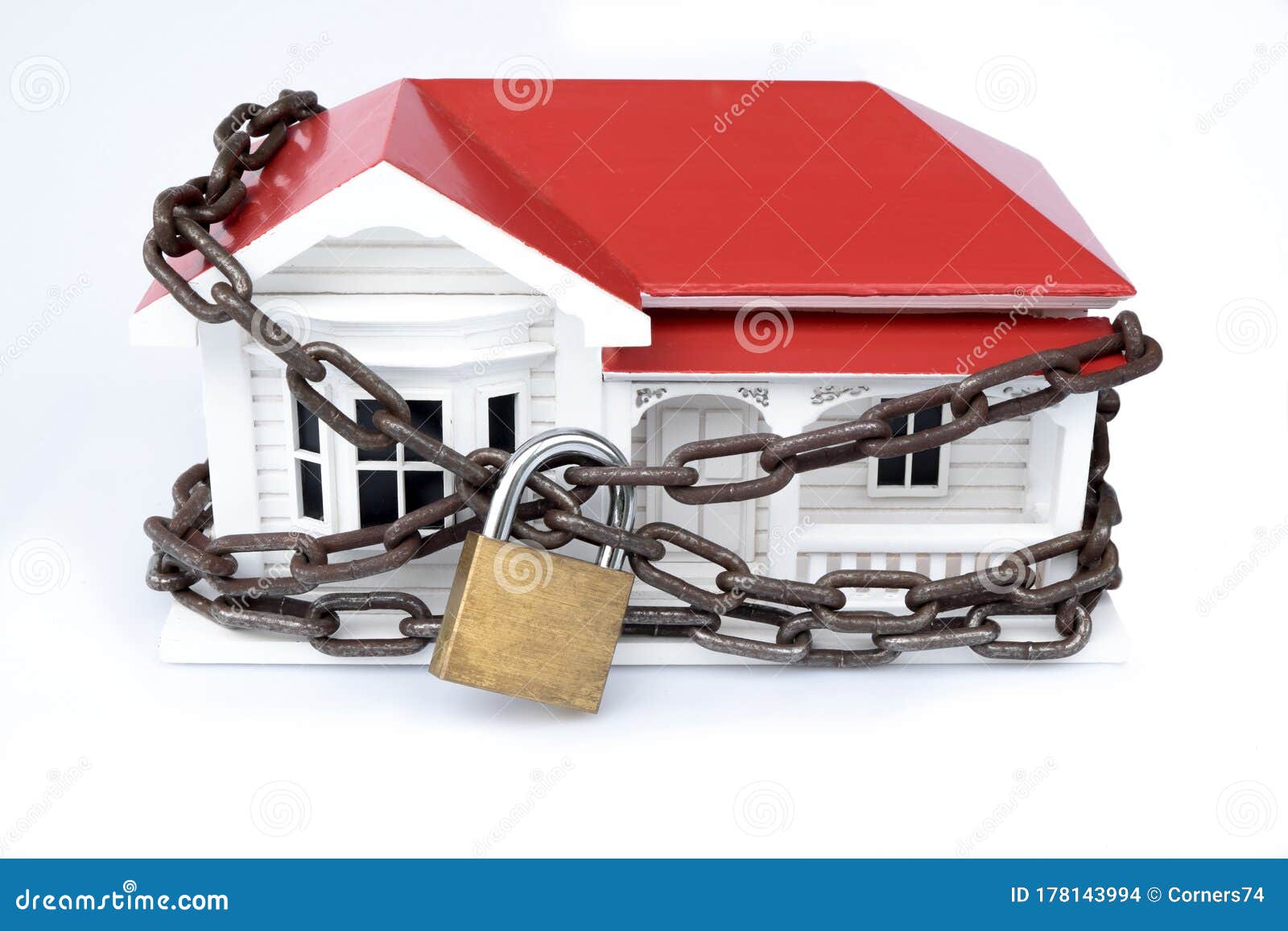 house arrest: locked down or quarantined concept of model home with chain and lock