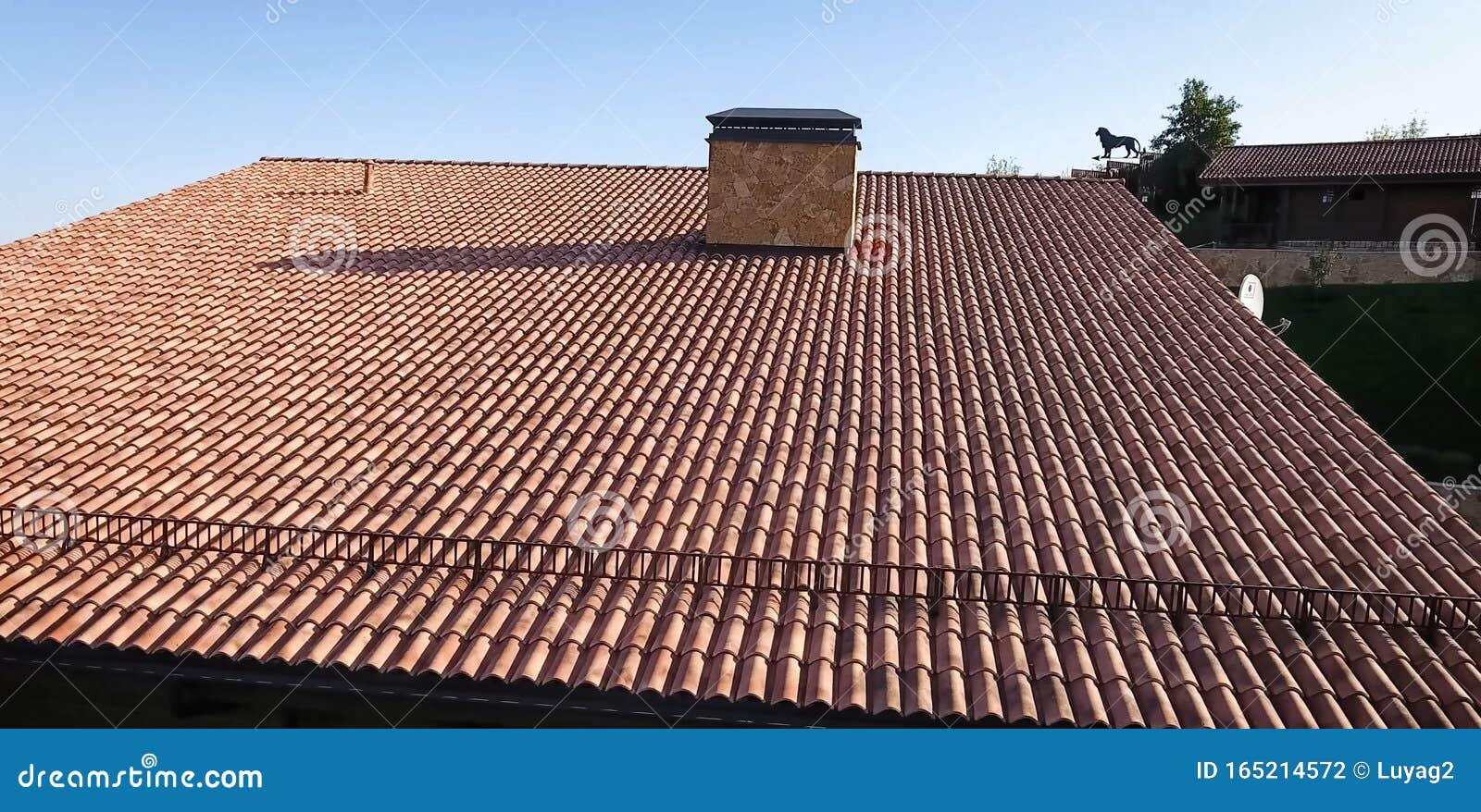House with Ceramic Tile Roof. Cementsand Roof Tiles Stock Photo
