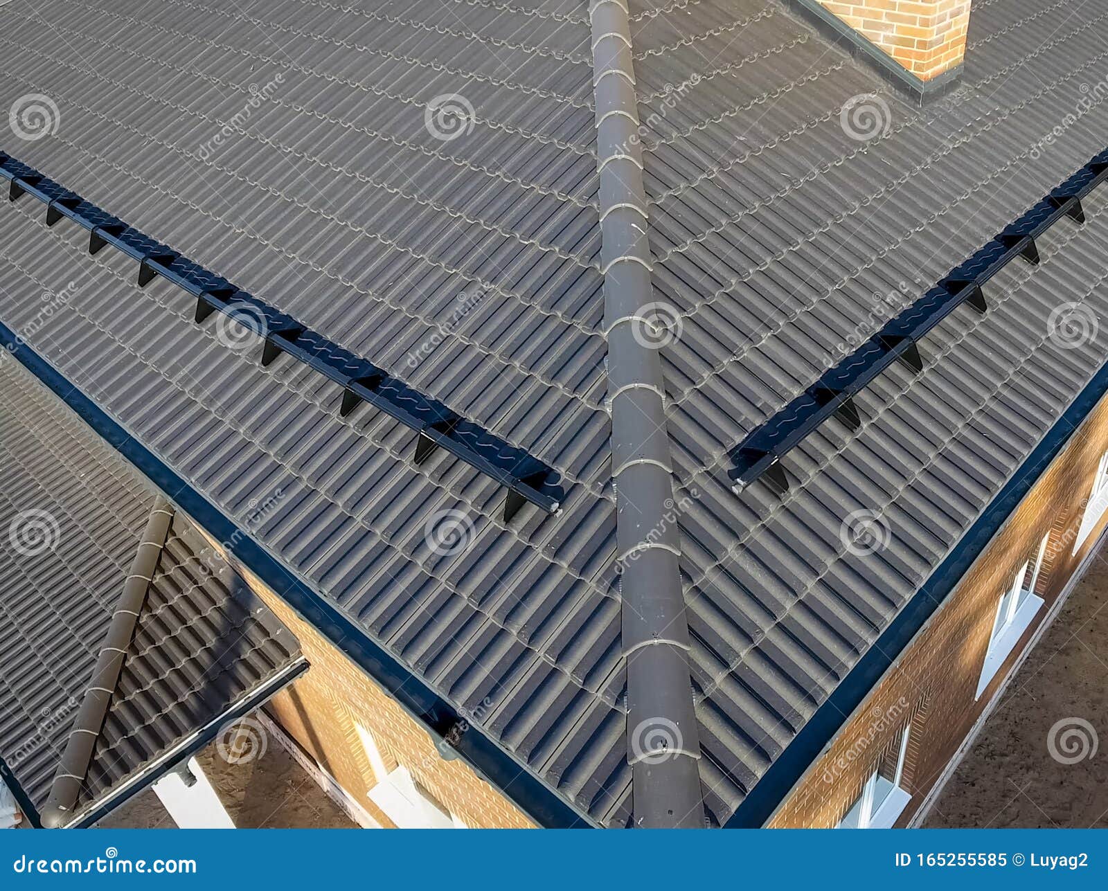 House with Ceramic Tile Roof. Cementsand Roof Tiles Stock Image