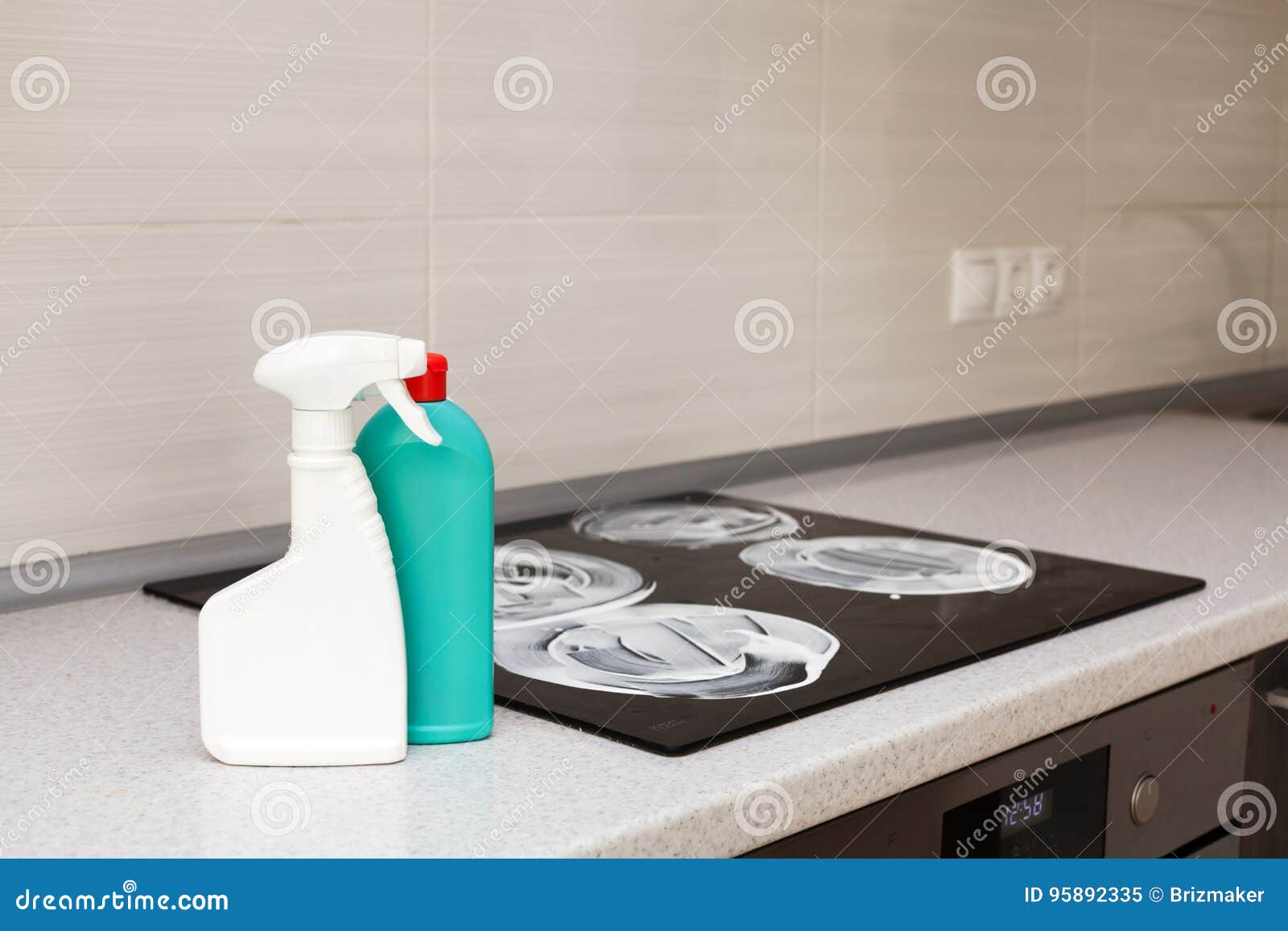 Stove and cooker red hot. Induction, ceramic cooktop, electric stovetop and  hob in kitchen. Warm plate ready for cooking. Contemporary interior design,  modern counter and wood table., Stock image