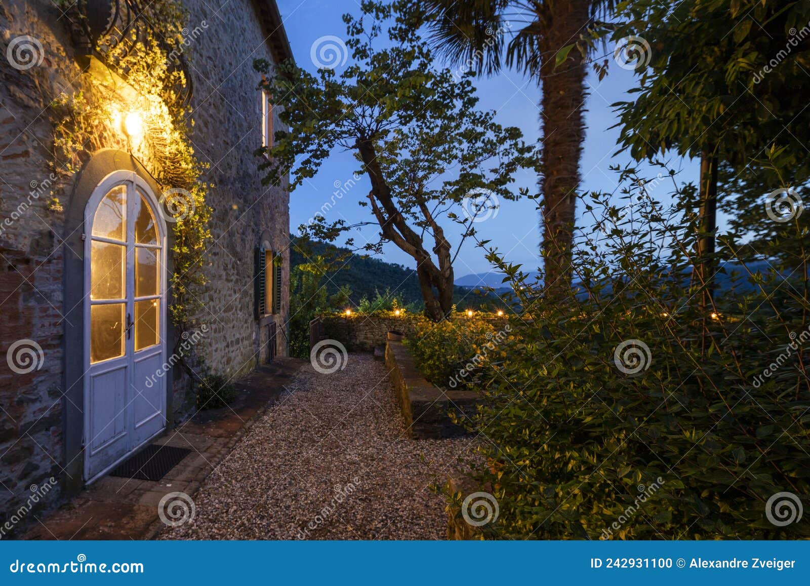 house or cottage at sunset with a beautiful garden in tuscany. the place is romantic and makes you dream