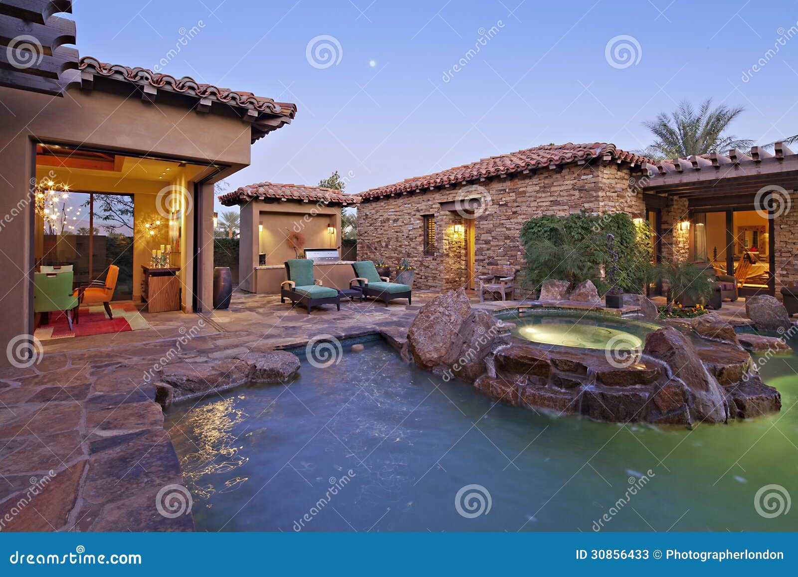 house exterior with swimming pool and hot tub