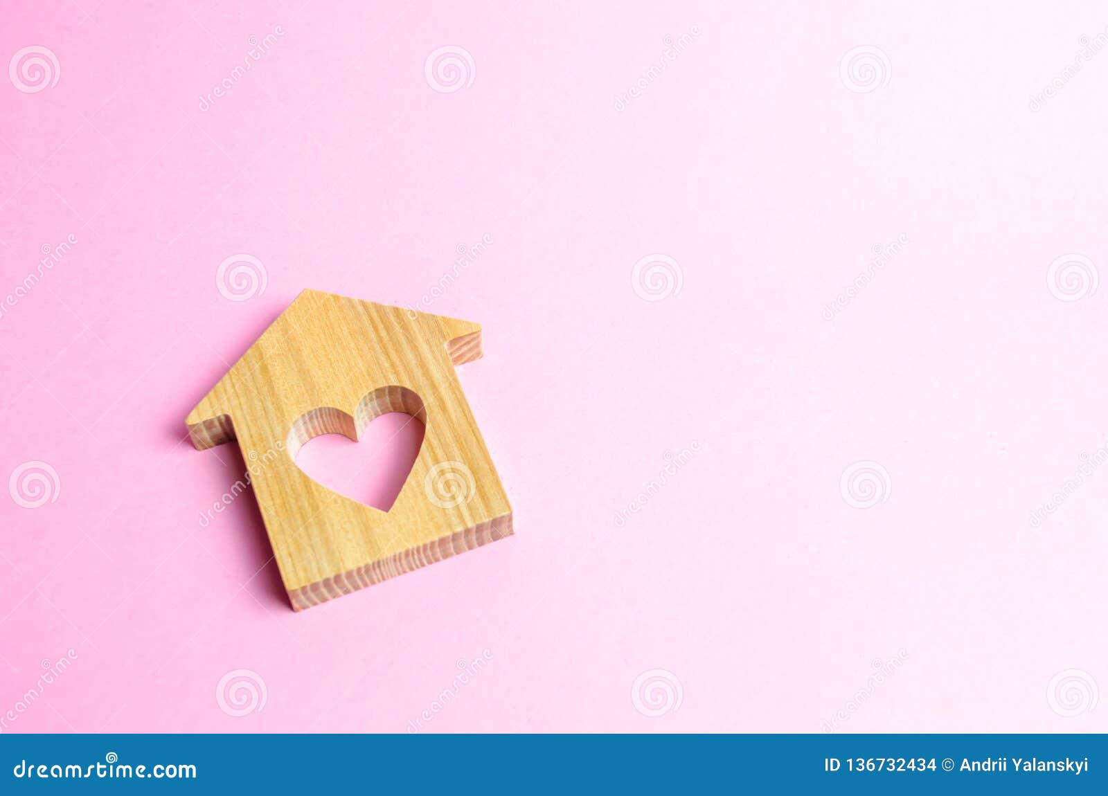 house with a heart on a pink background. the concept of finding a rental house or apartment for a romantic pastime.