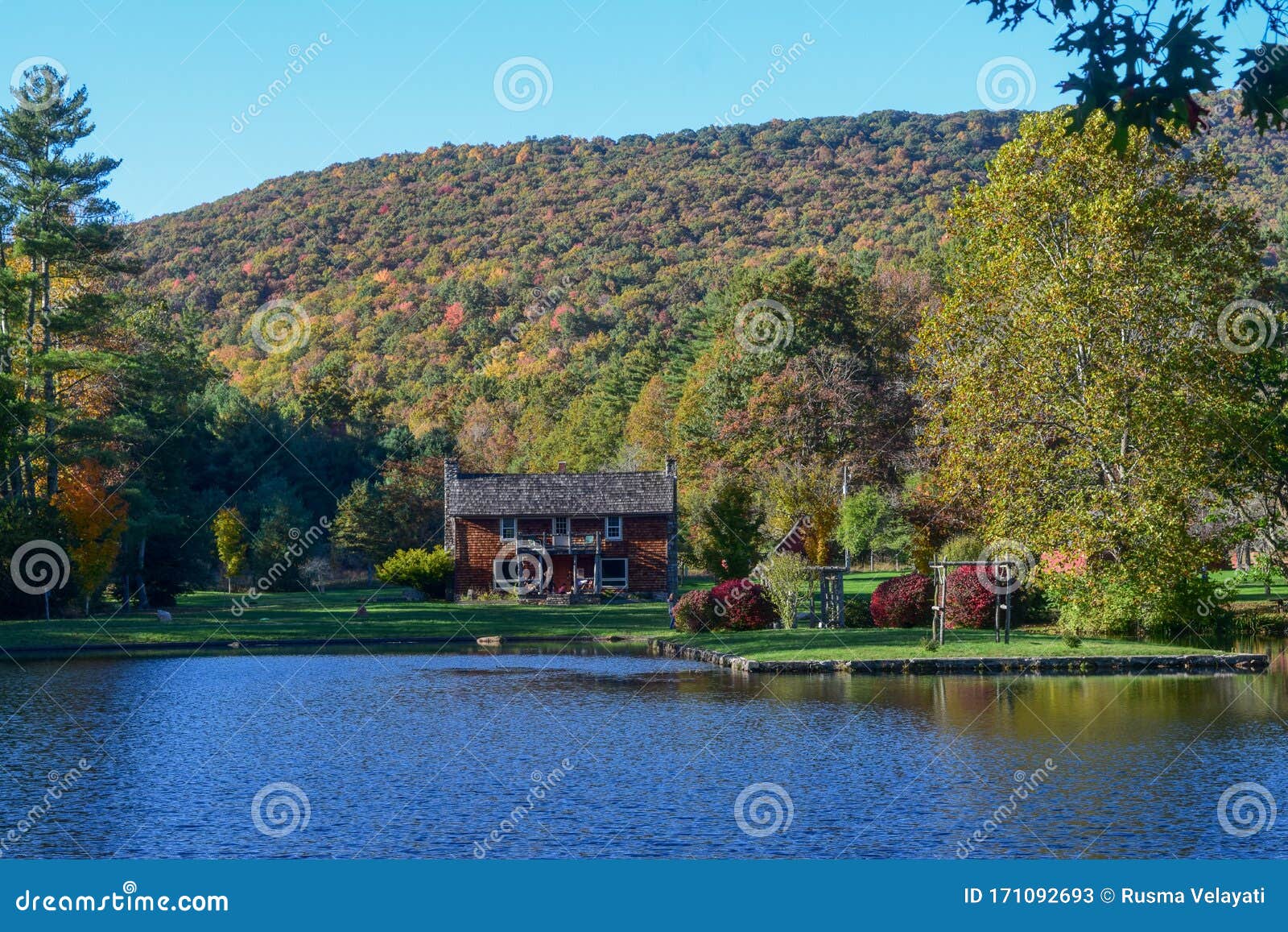 house by the lake at glen alton recreation area in autumn,