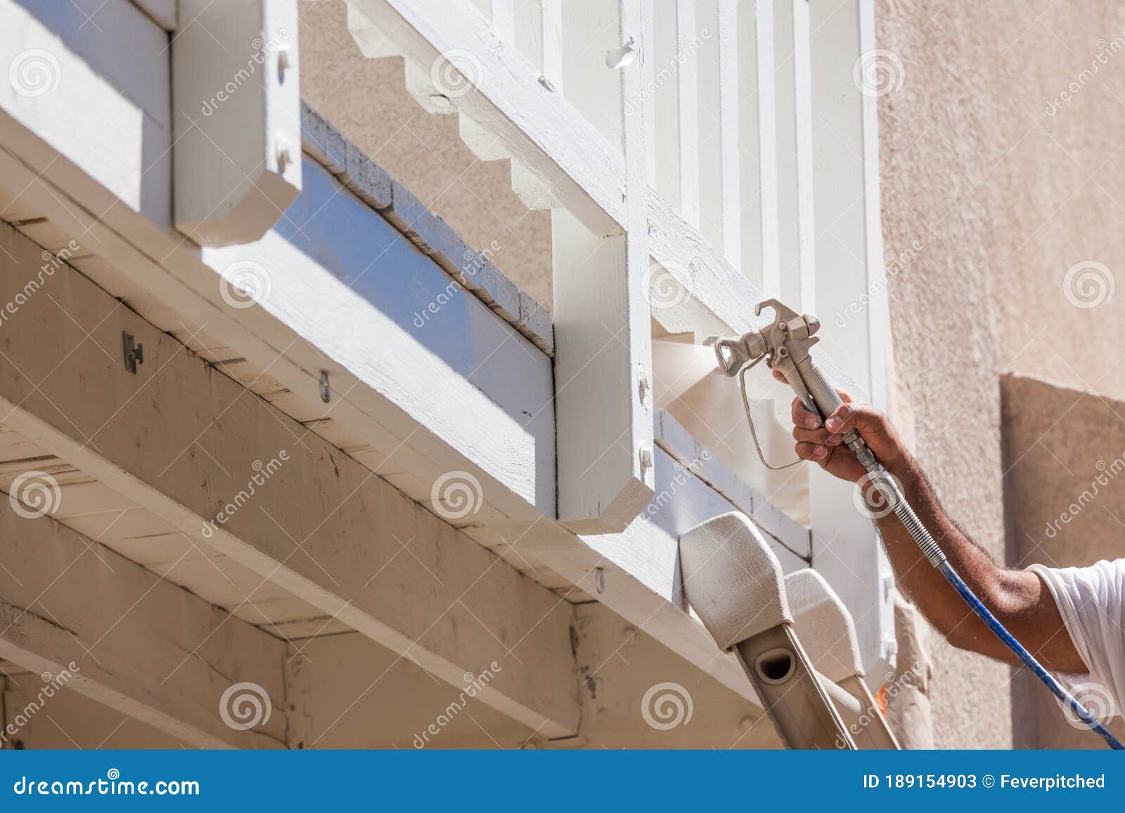 House Painter Spray Painting a Deck of a Home Stock Image Image of