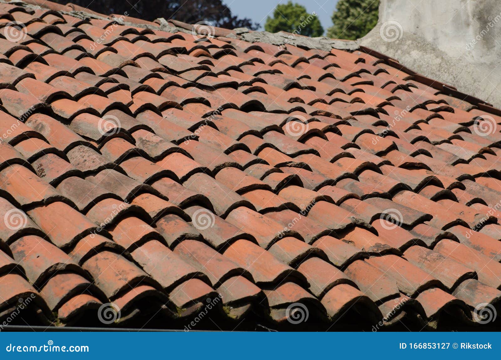 house with pitched roofs with brick tiles.