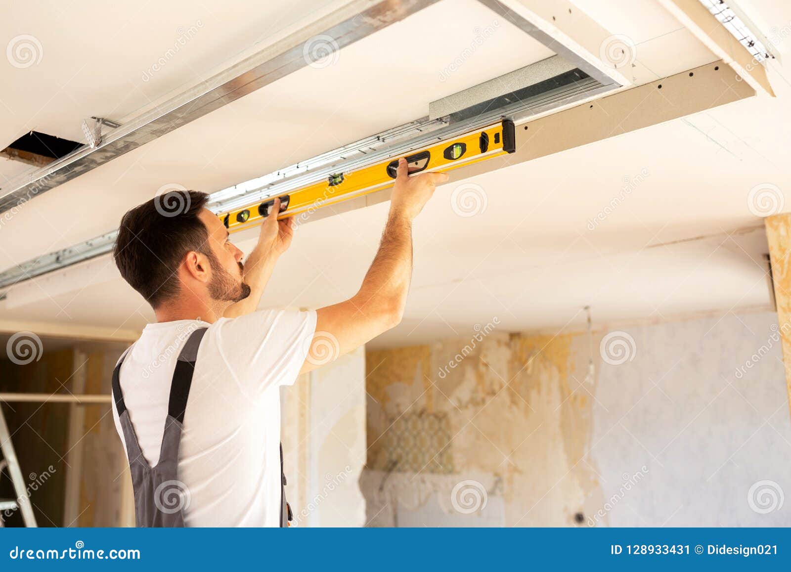 House Renovation Worker Checking The Alignment Of A Ceiling