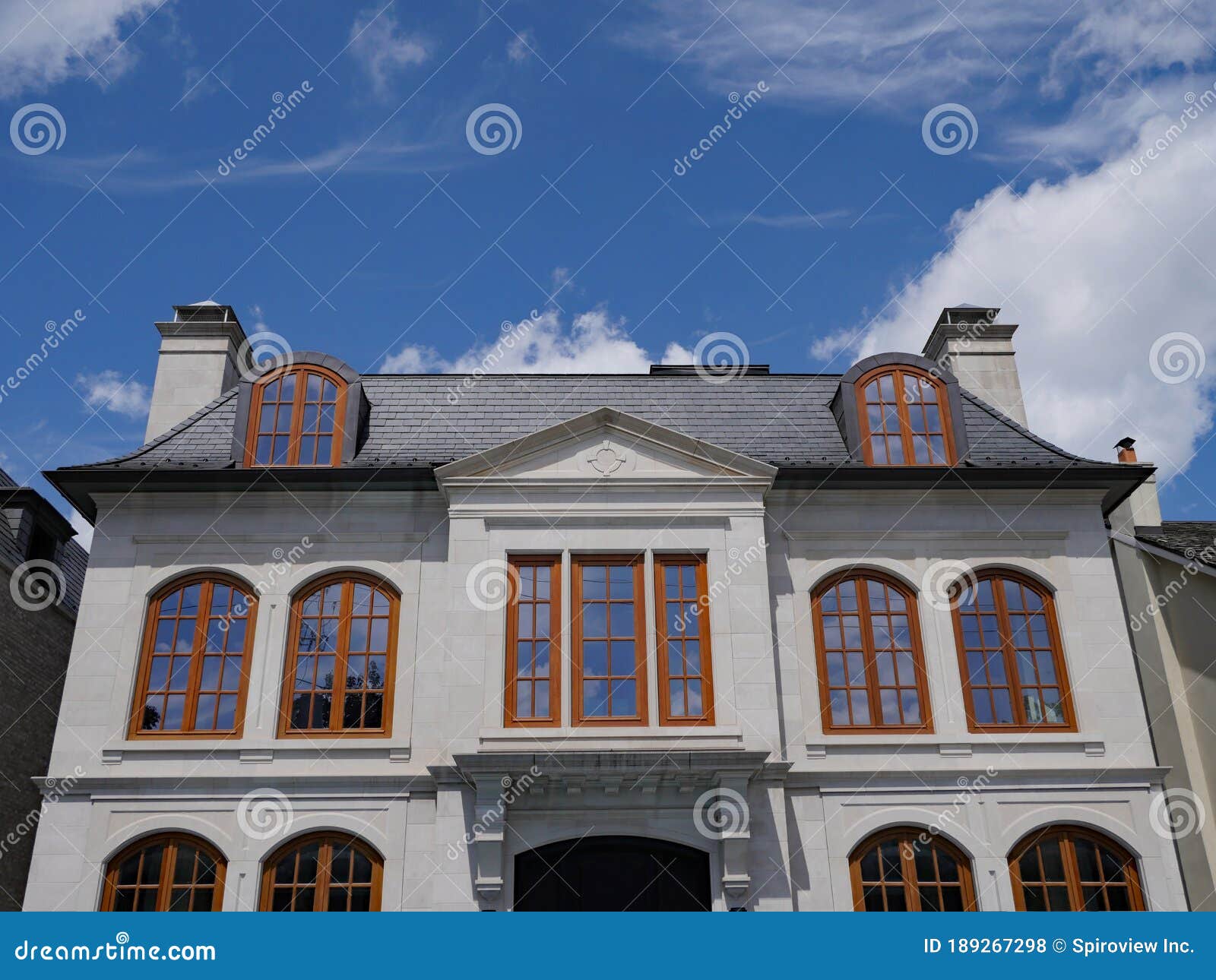 house with round topped brown casement windows