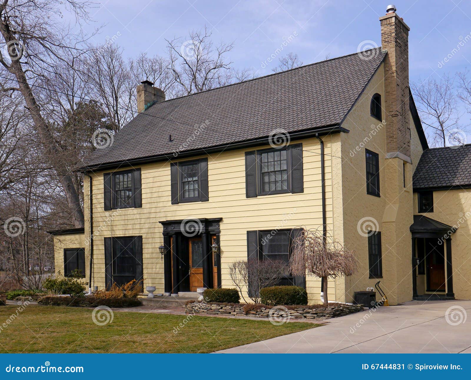 House with yellow siding stock image. Image of shutters 67444831