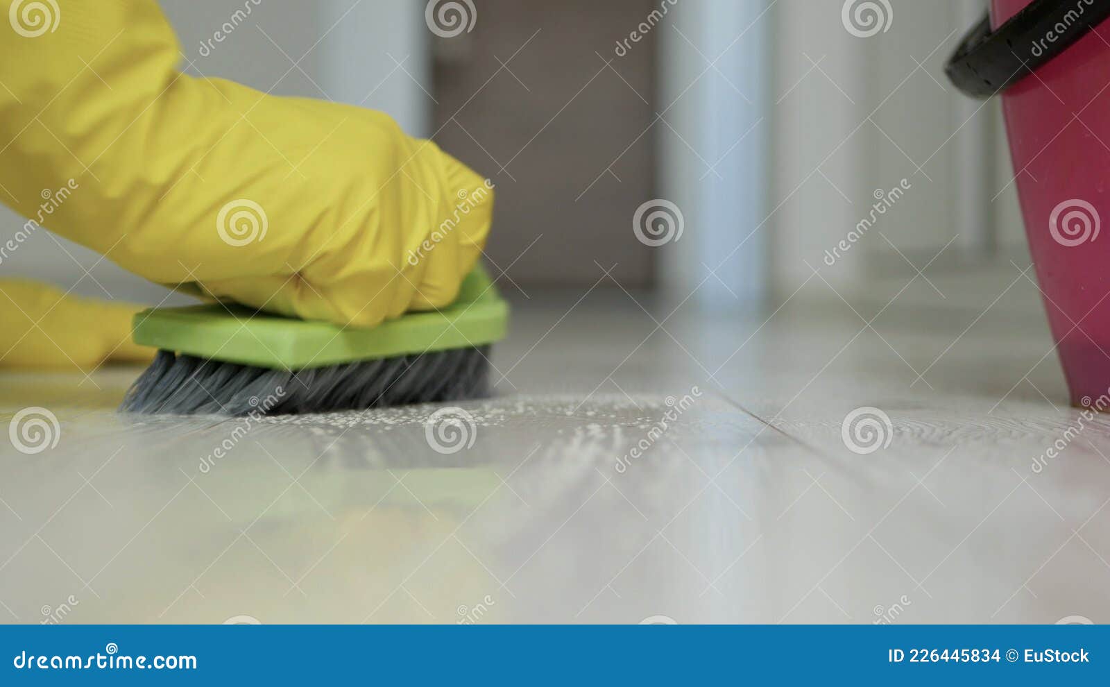 Housekeeper Wearing Protective Gloves Cleaning Dirty Floor Stock Photo