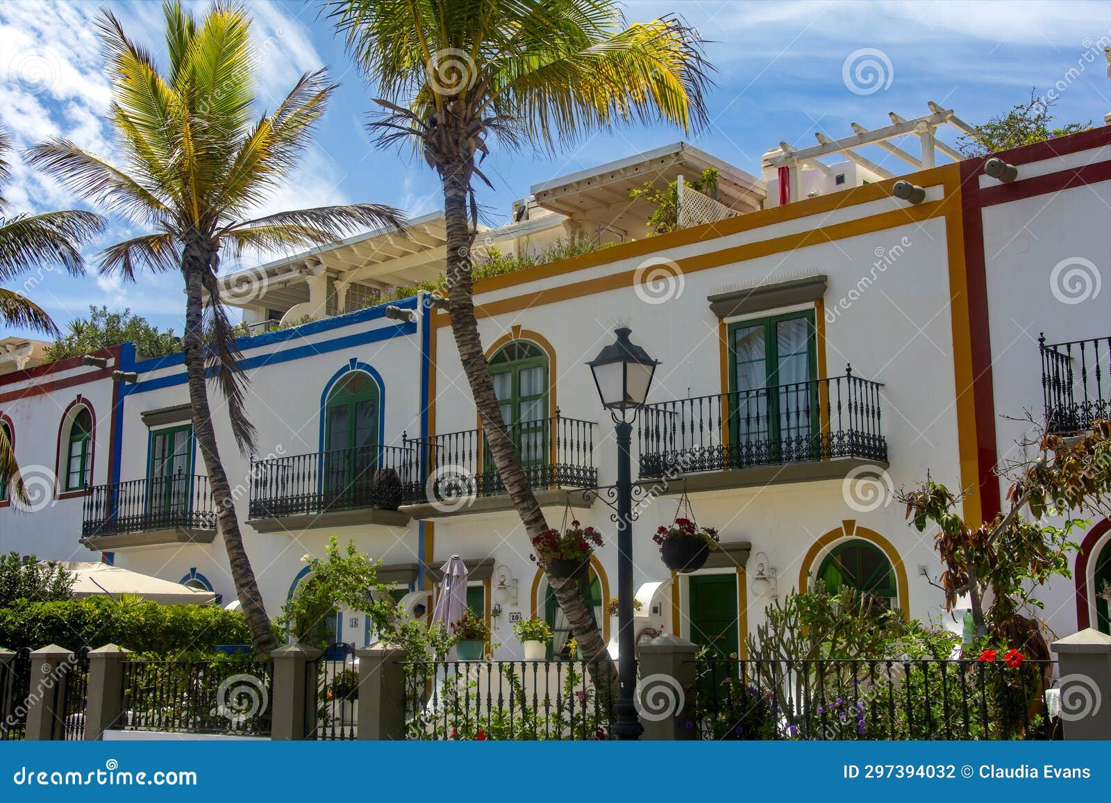 houses and palm trees in the spanish town of puerto de mogan