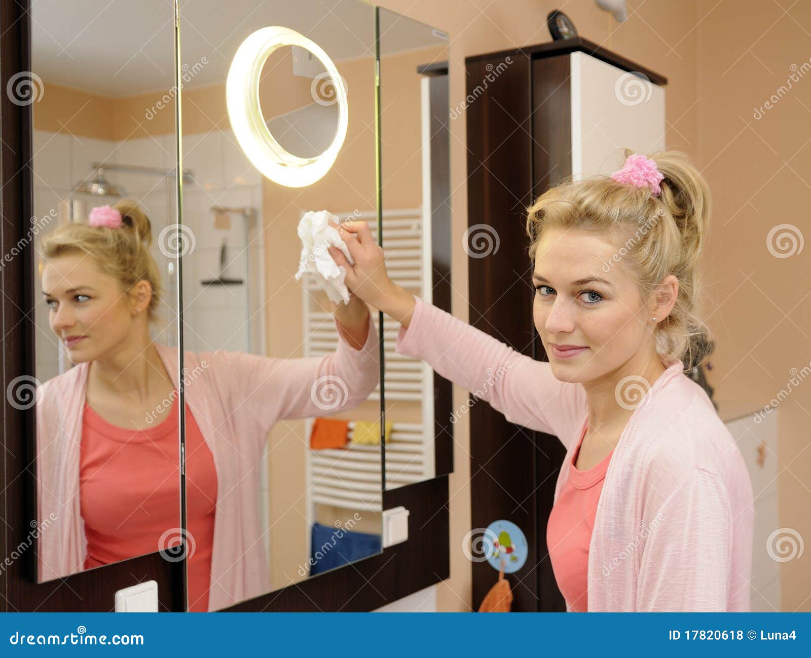 Housewife cleans a mirror stock photo. Image of bathroom 17820618