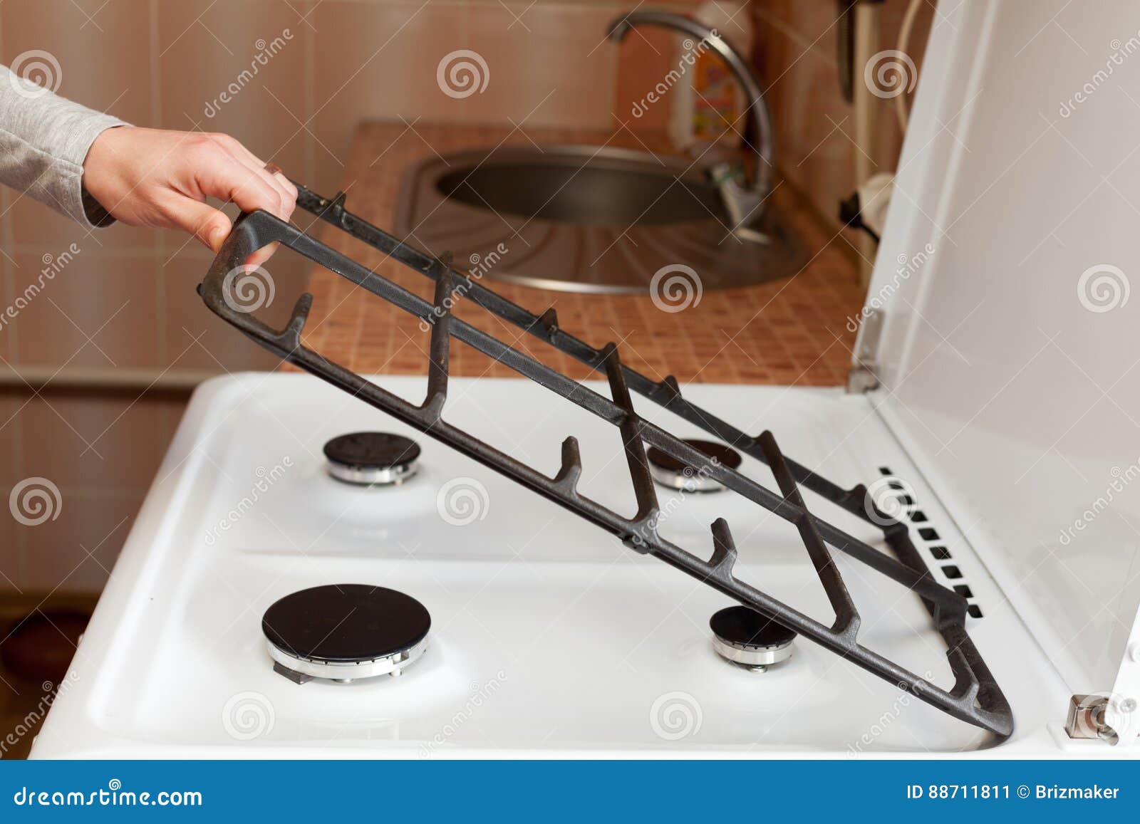 Housewife Hold Metal Grates To Clean The Dirty Kitchen Gas Stove Housewife Hold Metal Grates To Clean The Dirty Kitchen Gas Stove