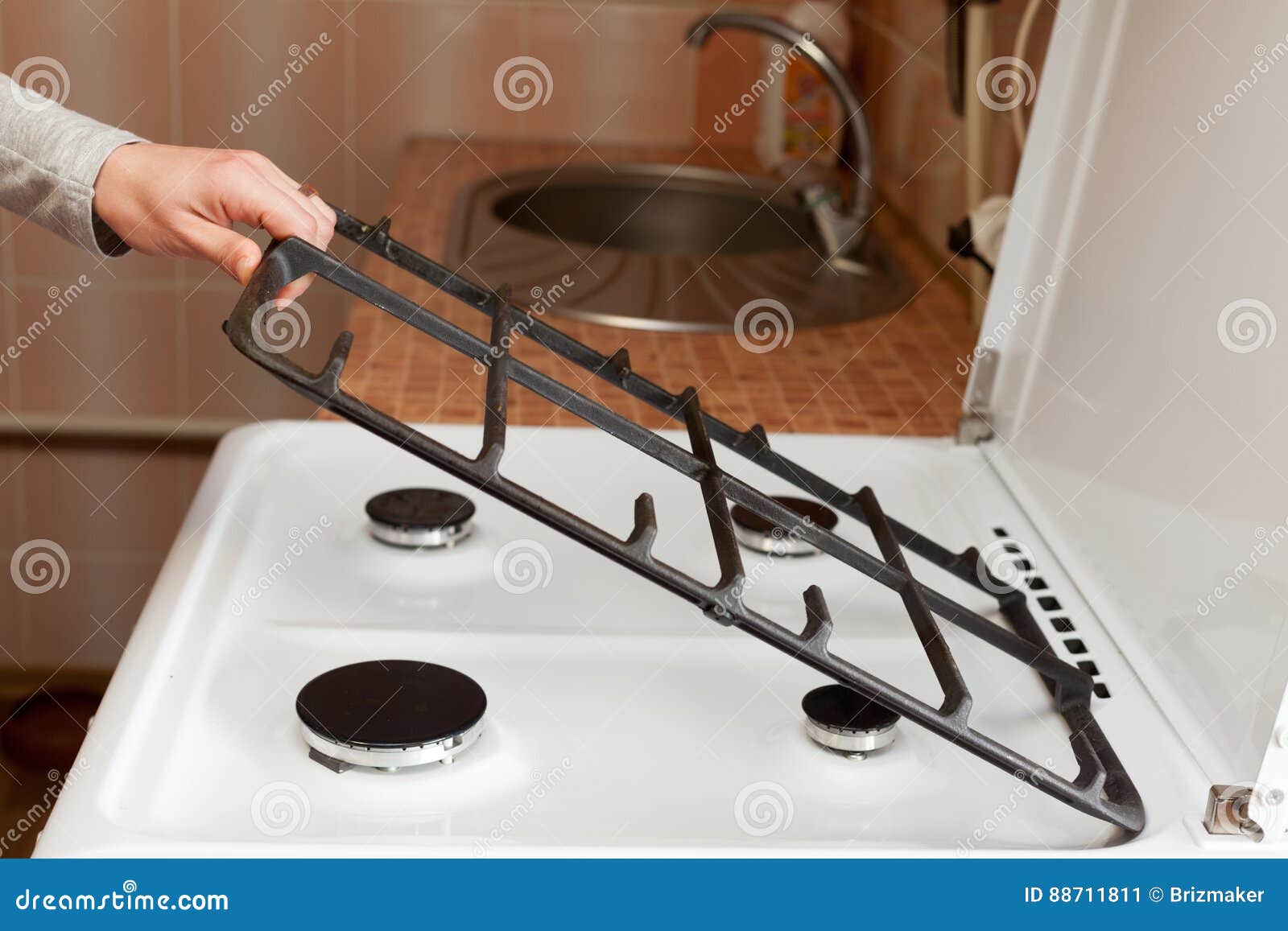 Housewife Hold Metal Grates To Clean The Dirty Kitchen Gas Stove