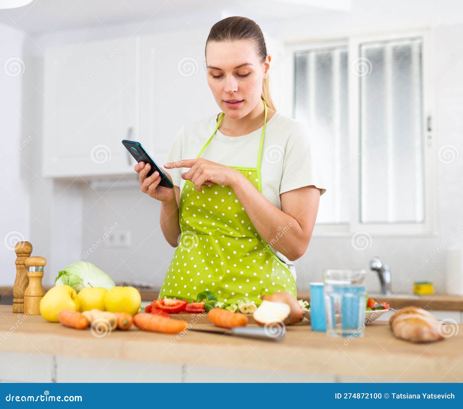 Housewife Looking for Recipe on Using Smart Phone in the