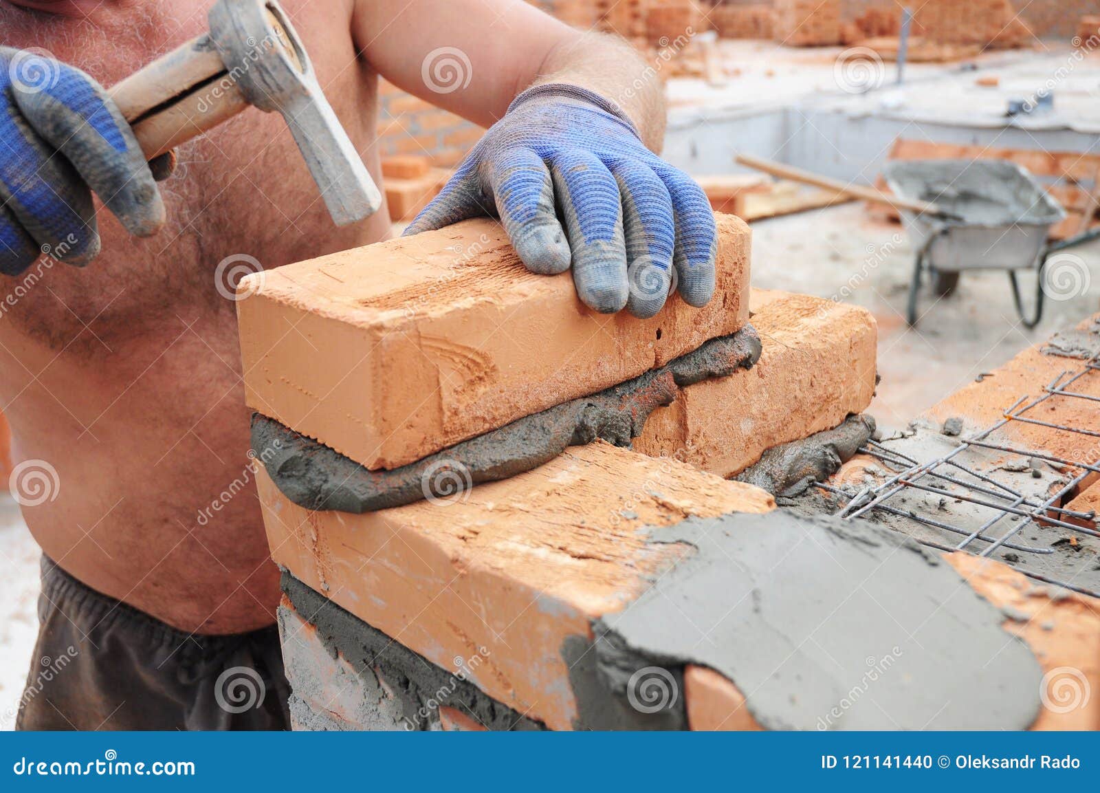 How To Lay Bricks Bricklayer Laying Bricks with Hammer. Masonry Construction. Stock Photo