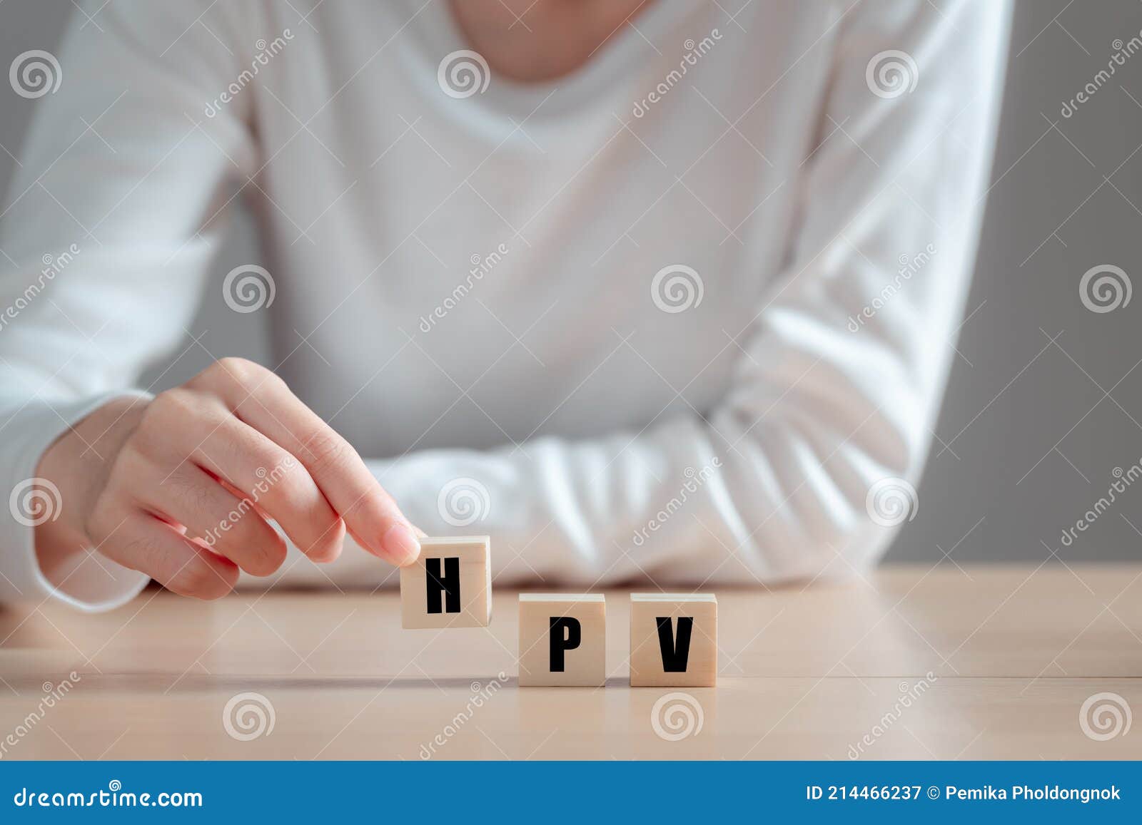 hpv human papillomavirus acronym on wood block, asian woman  holding wooden block, viruses some strains infect genitals and can