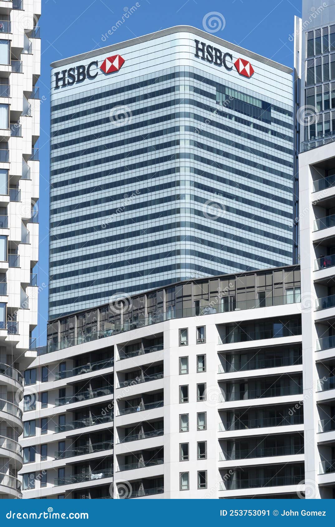 HSBC bank building at Canary Wharf, London, UK. Canary Wharf, London, UK. 11th August 2022. Low angle view of the HSBC Group building located at Canary Wharf in London`s Docklands district, against a clear blue sky.