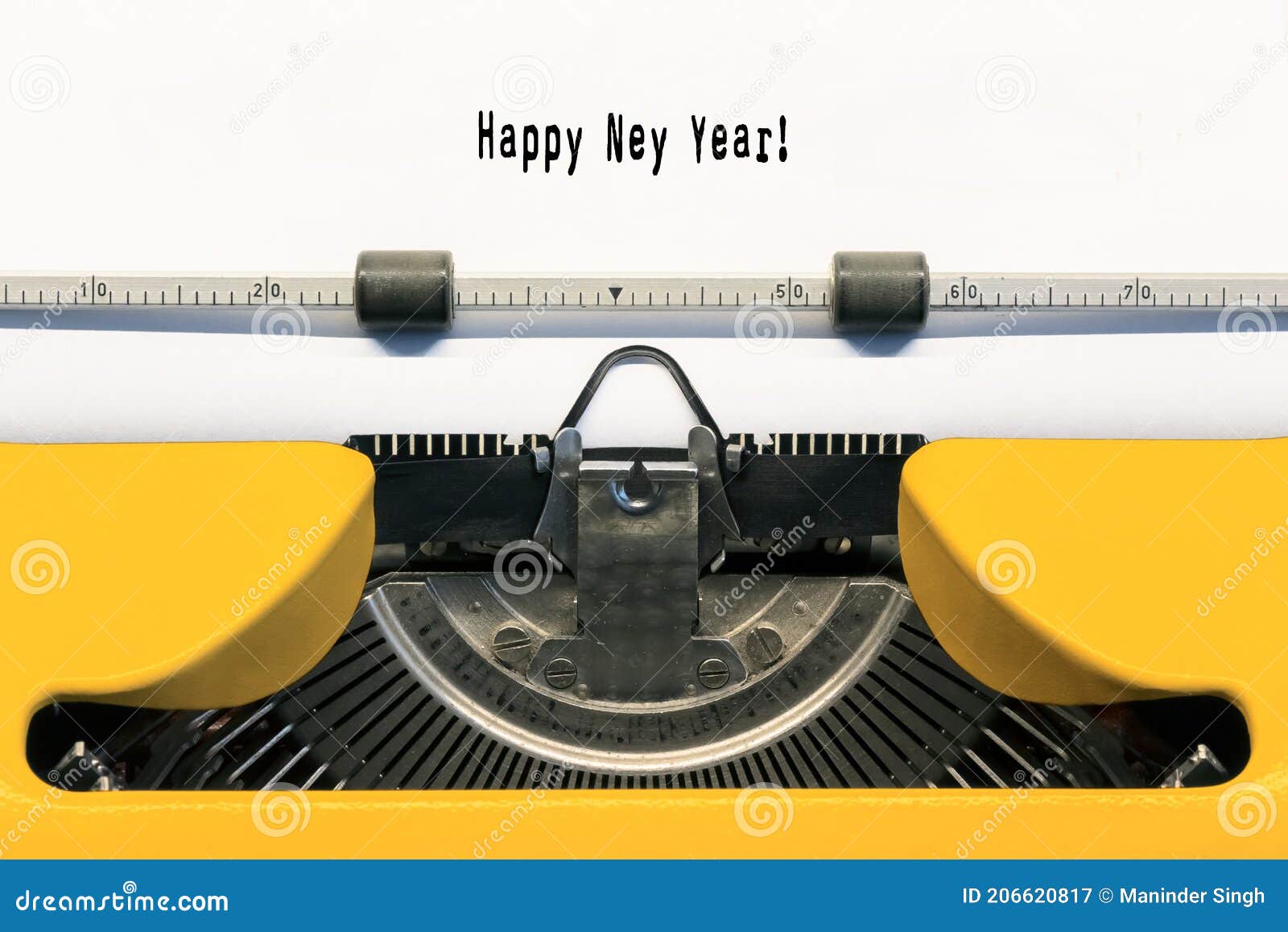 happy new year typed on yellow typewriter.