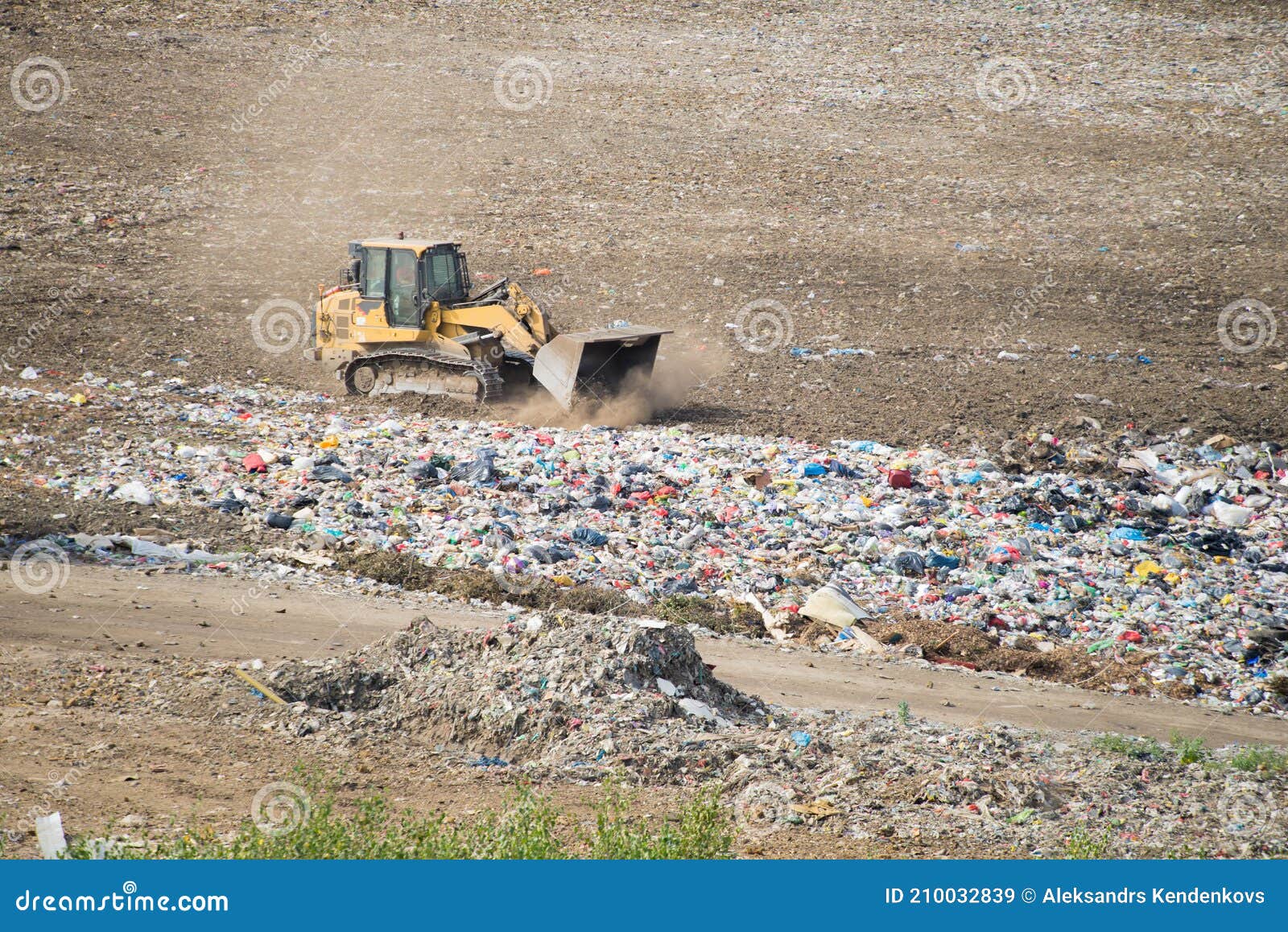 Huge Dump with Different Types of Garbage. Yellow Tractor. Waste Sorting on Landfill. Caring for