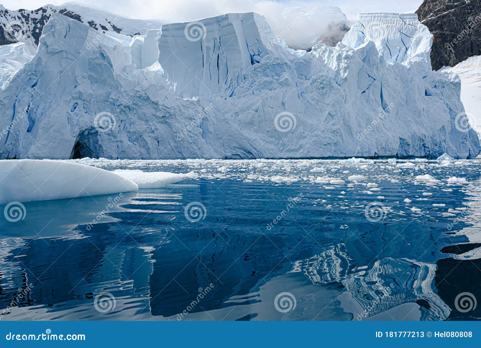 glacier ice shelf in antarctica, majestic blue and white glacier edge reflecting in blue sea water, paradise bay, antarctica