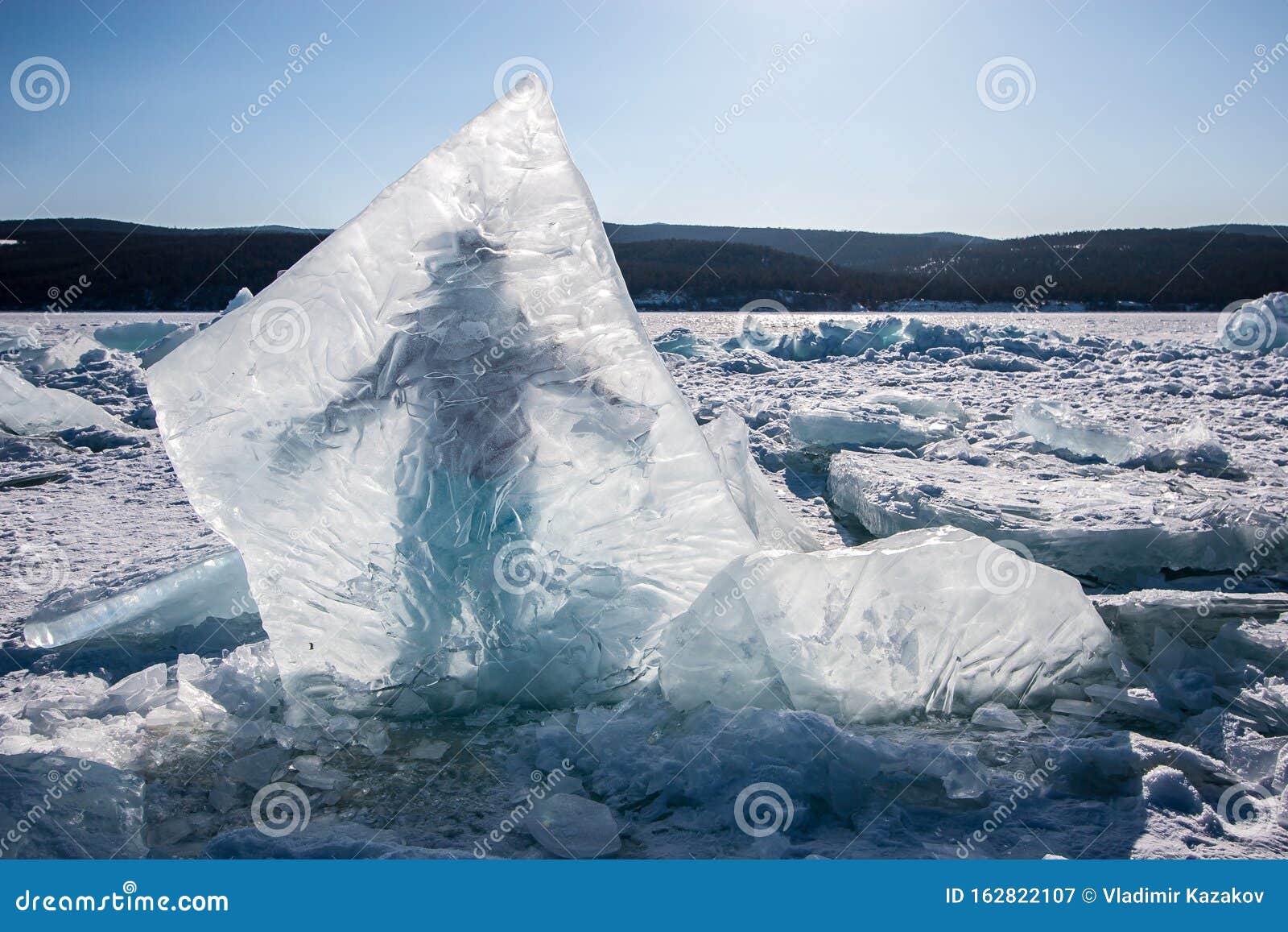 A Huge Ice Piece Frozen into Lake Baikal, Behind Which a Man Stands ...