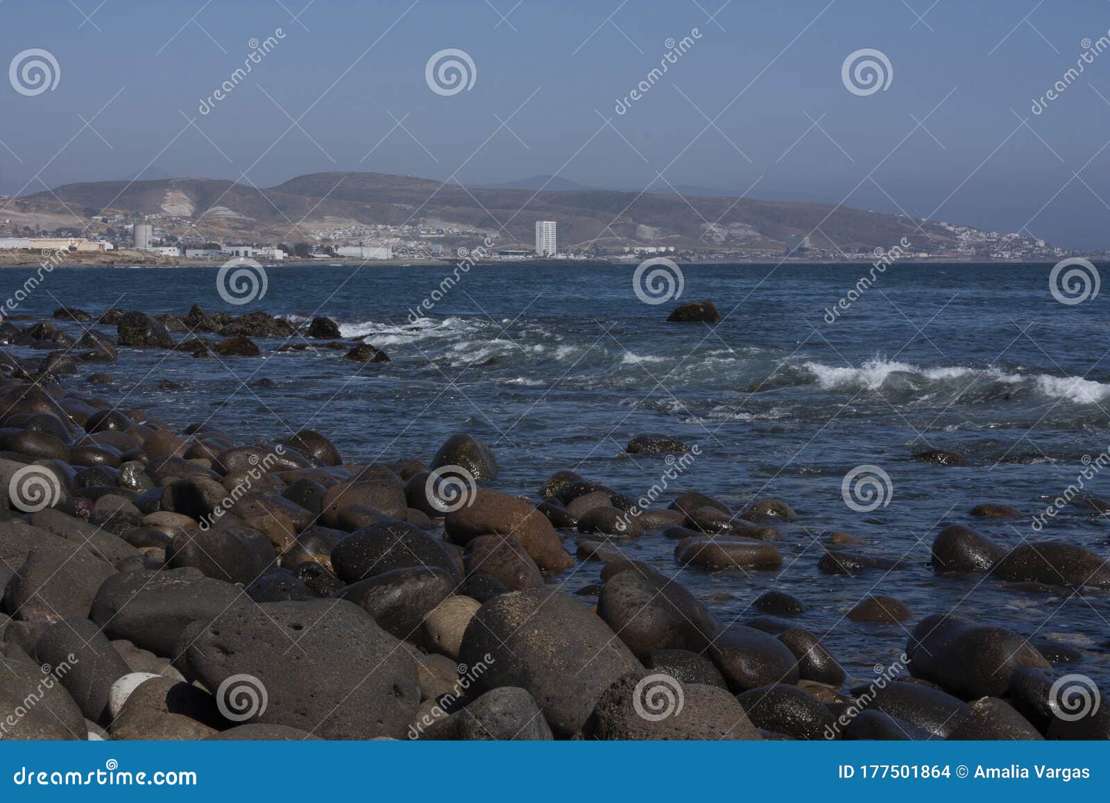 landscape with huge rocks blue sea foam waves and blue sky beach of baja california mexico
