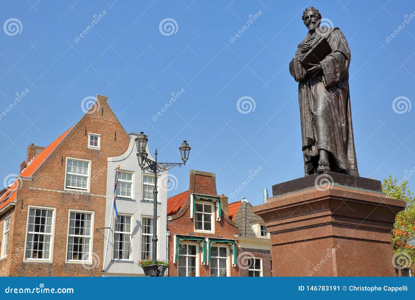 hugo de groot monument dating from 1886 on the main square markt with traditional and colorful facades in the background