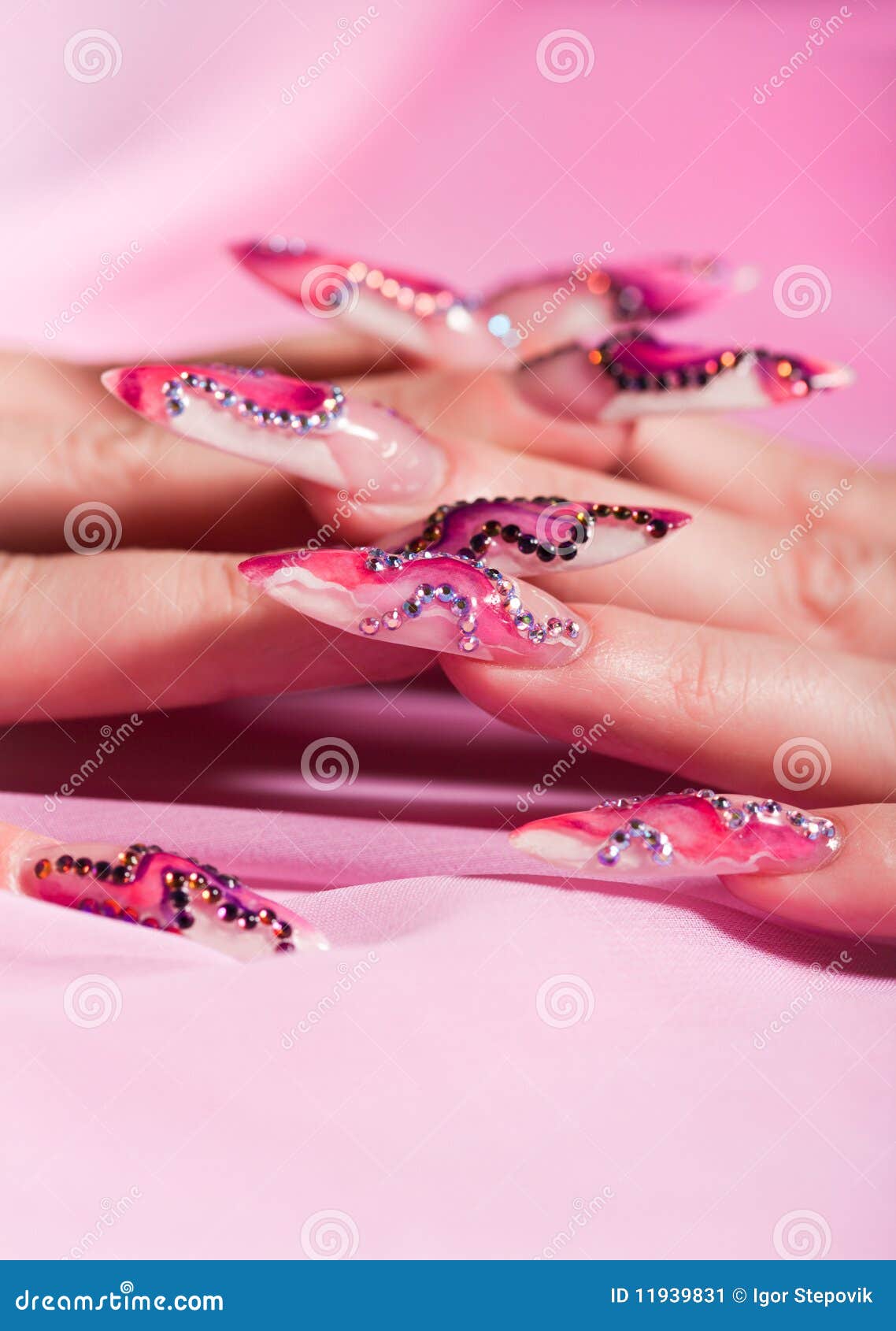human fingers with long fingernail over pink