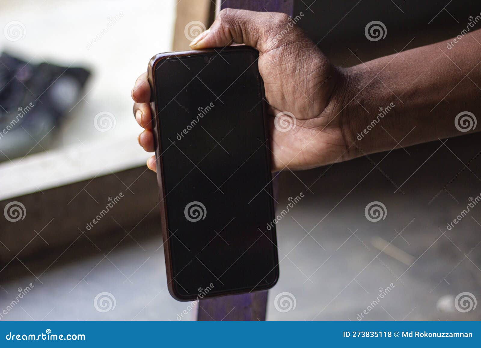 A Human Hand Holding a Black Screen Mobile Phone for Mock Up Stock