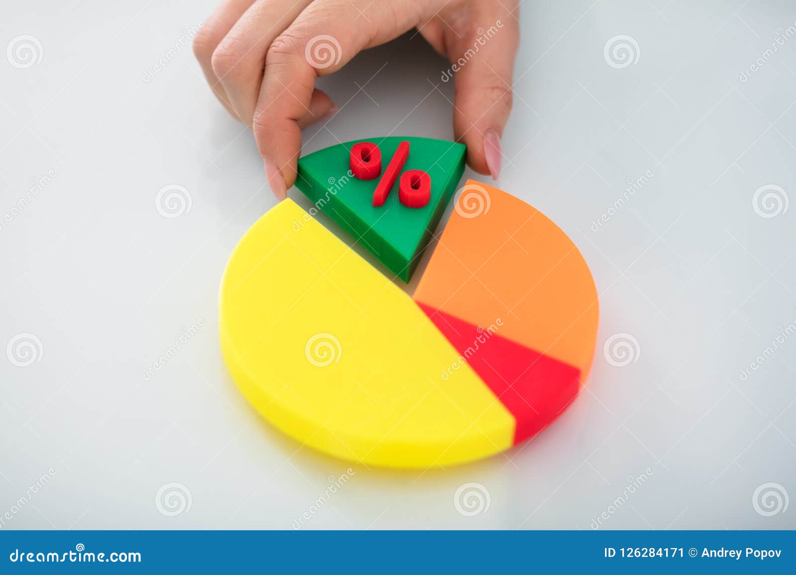 human hand taking piece of pie chart with percentage 