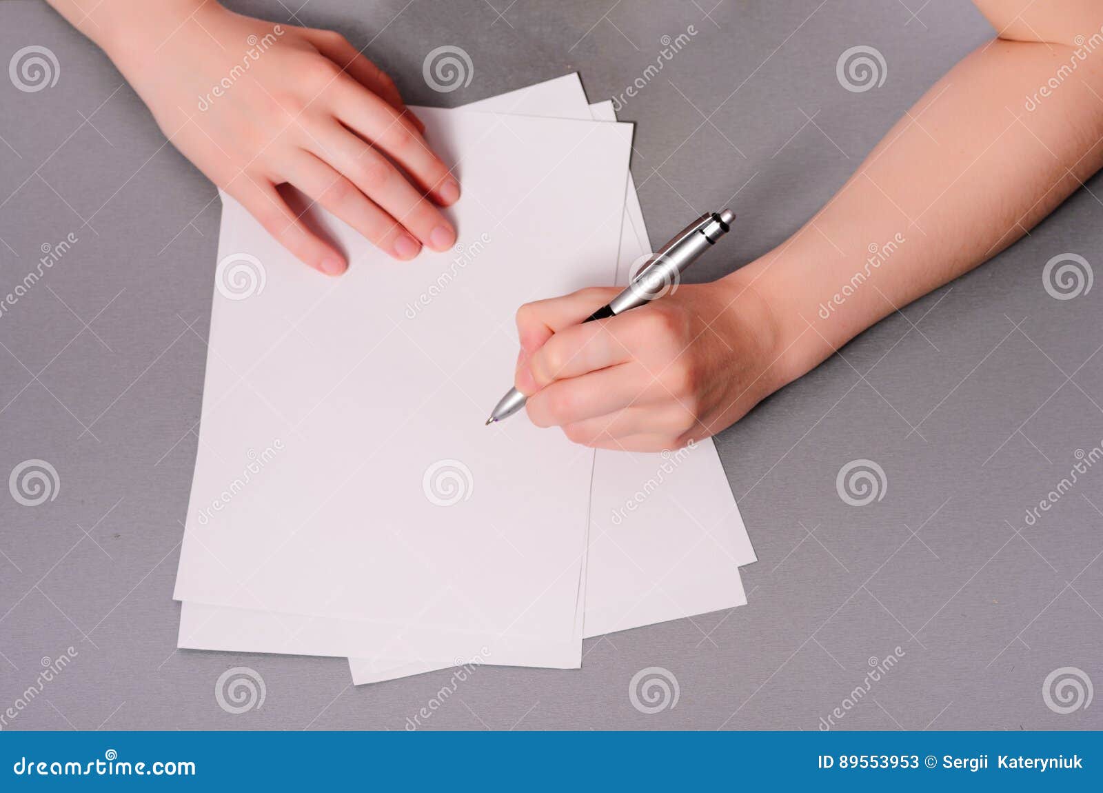 Human Hands with Pencil Writing on Paper and Erase Rubber on Wooden ...