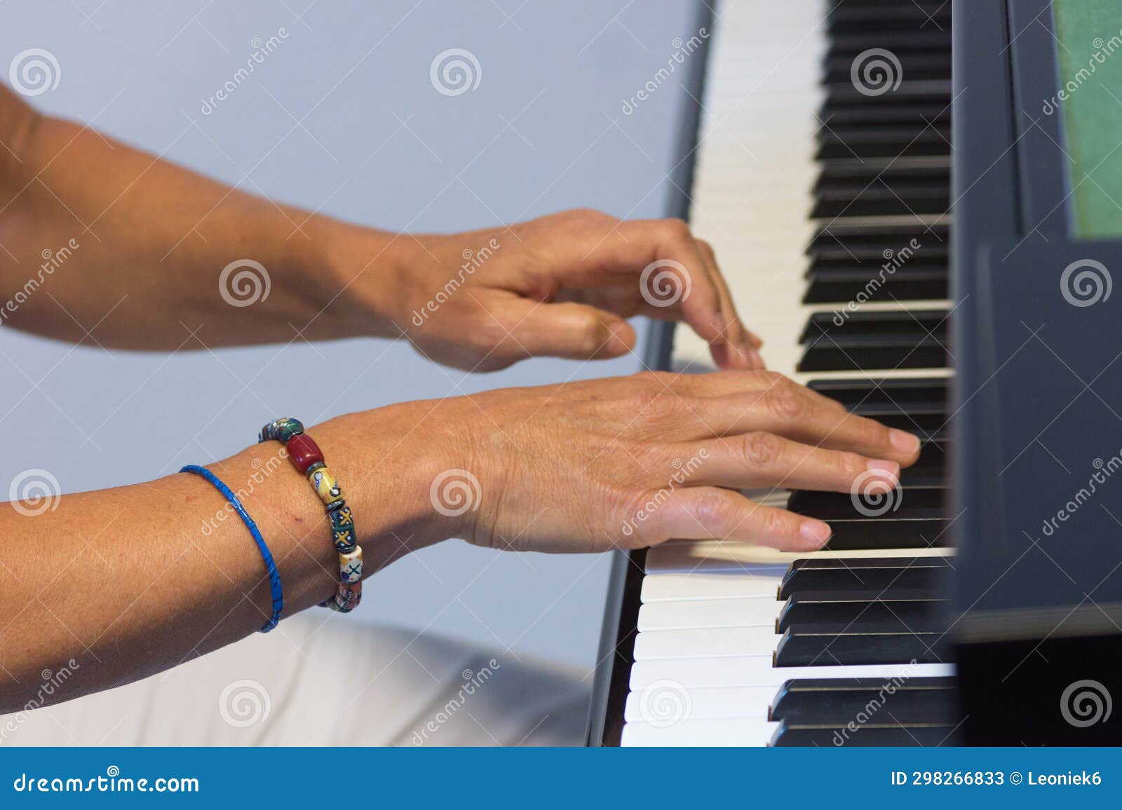 Human Hands Playing the Keys Notes and Chords on a Classic Black Piano