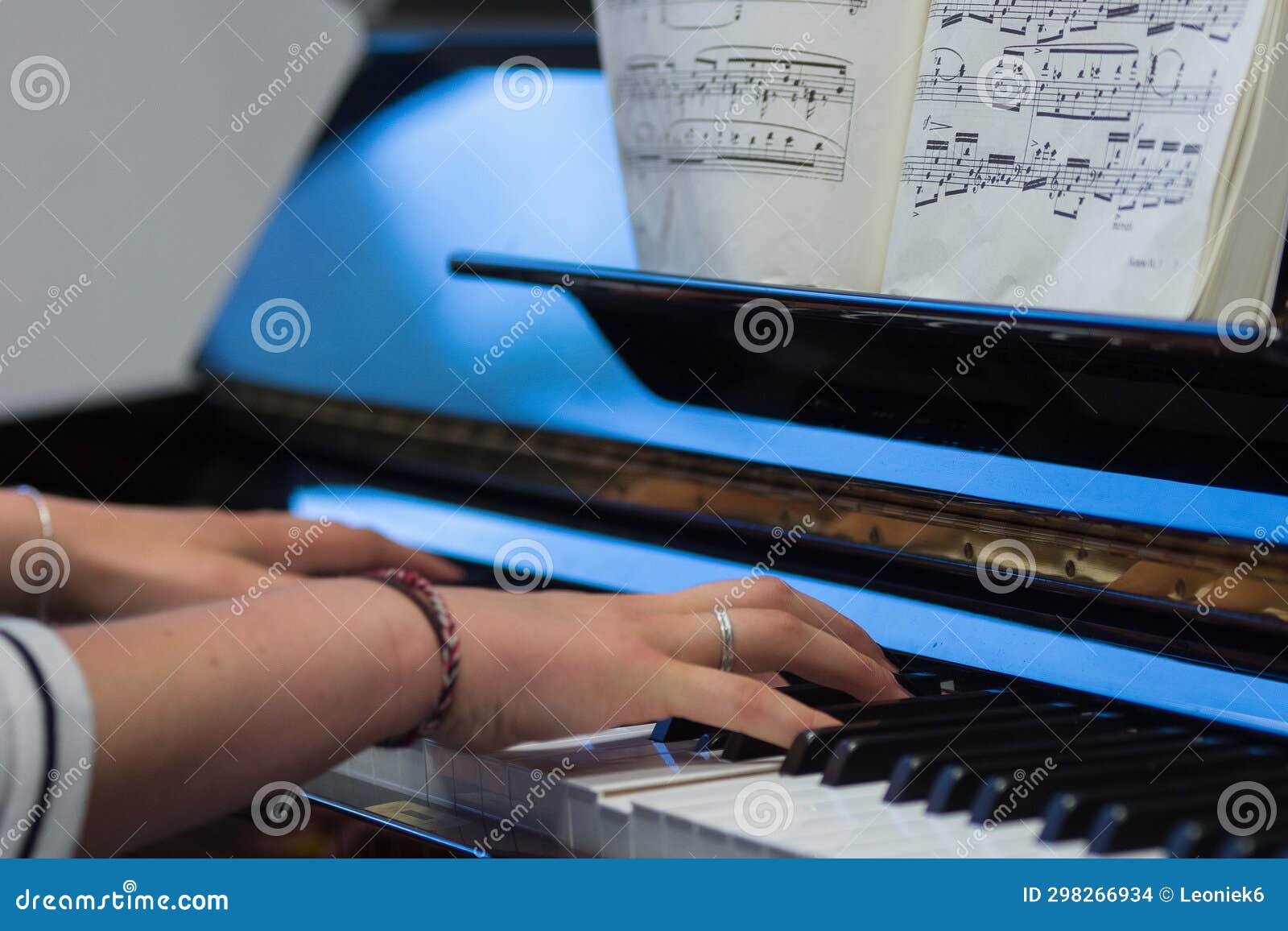 Human Hands Playing the Keys Notes and Chords on a Classic Black Piano