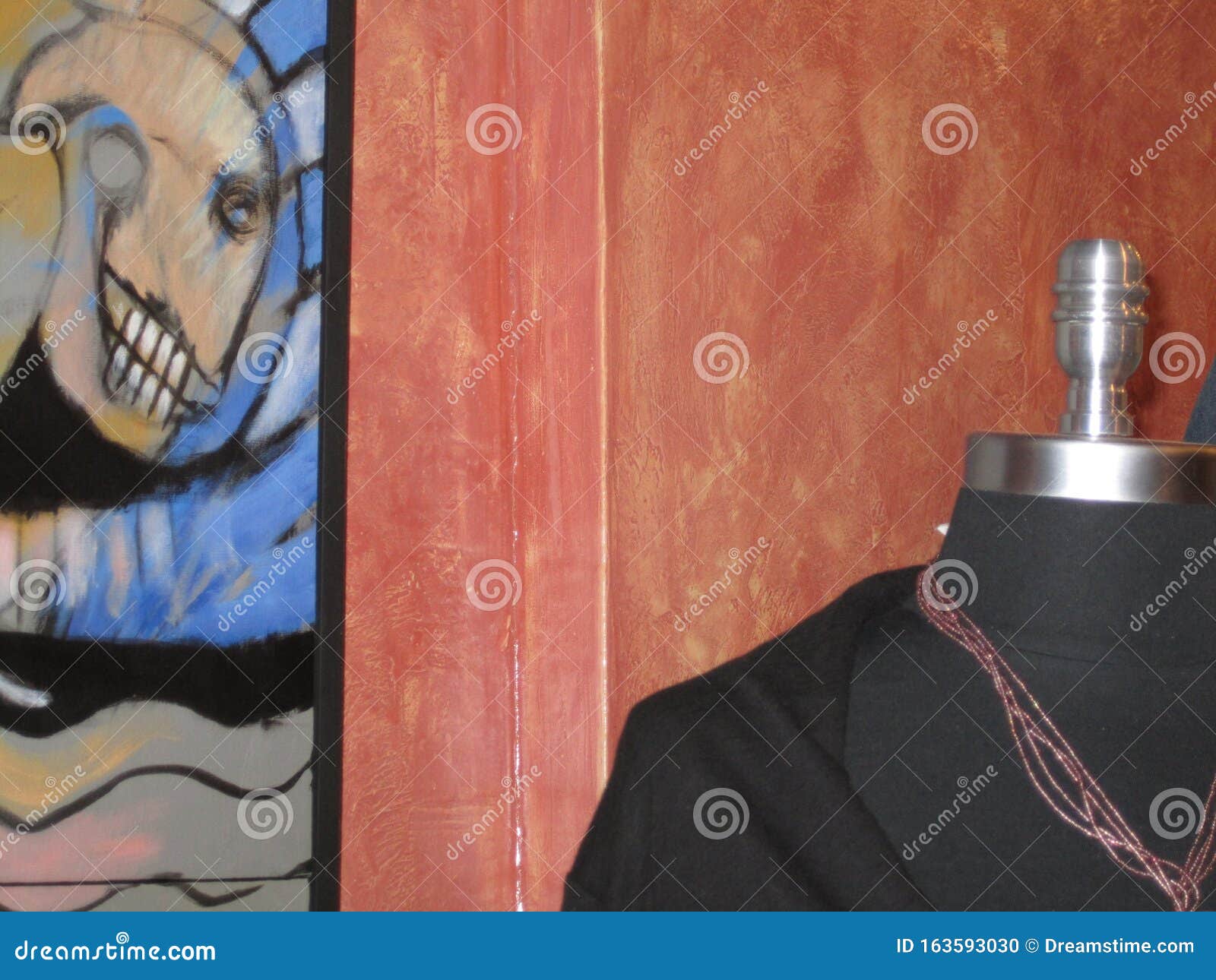 Humorous Juxtaposition of Headless Mannequin Aside a Painted Skull