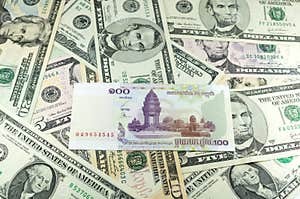 Hundred Cambodian Riel KHR On Many Dollars Background Stock Photos 