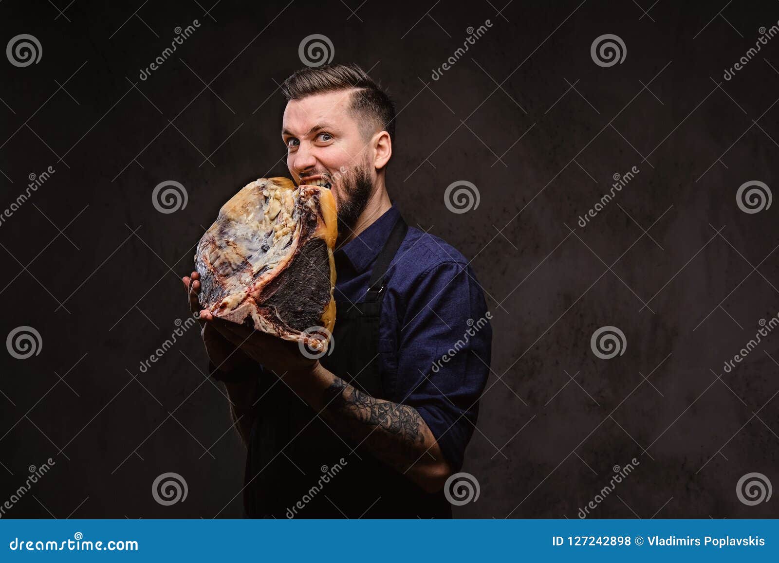 Hungry Chef Bites Large Piece of Exclusive Cured Meat on Dark