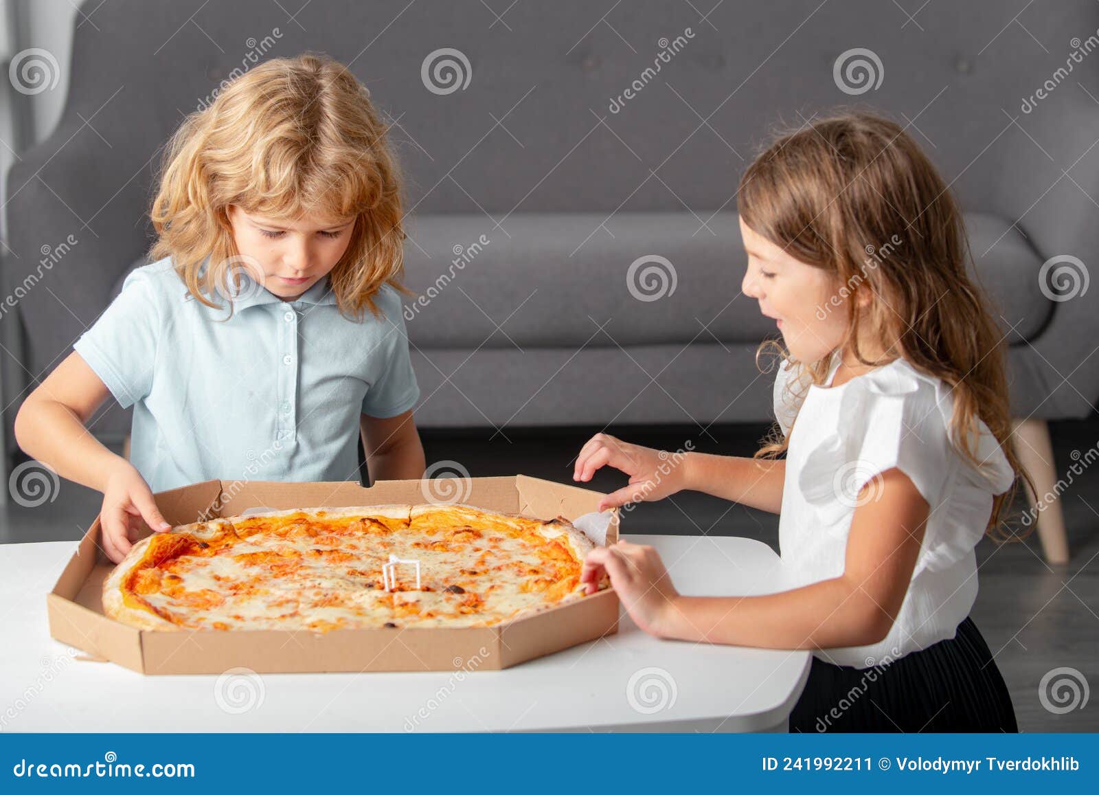 Hungry Children Eating Pizza. Kids Preparing To Eat Fresh Pizza. Stock