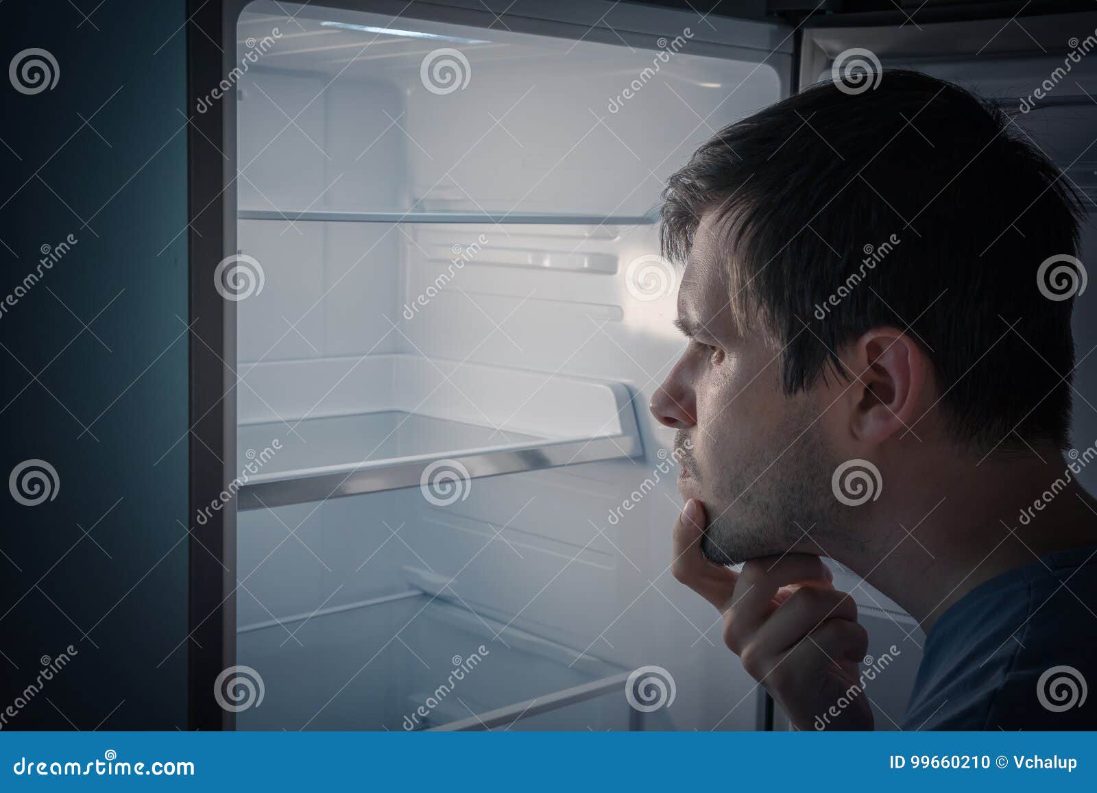 Hungry Man is Looking for Food To Eat in Empty Fridge at Night Stock