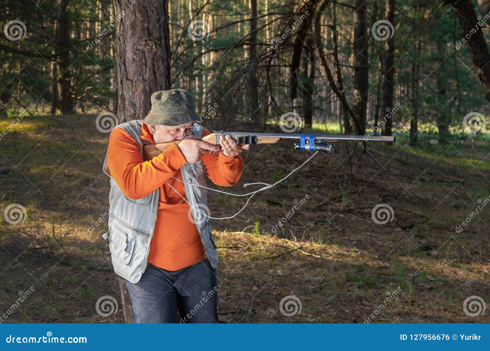 Hunter Aim Rifle in Forest Leaning on a Pine Tree Stock Photo Image