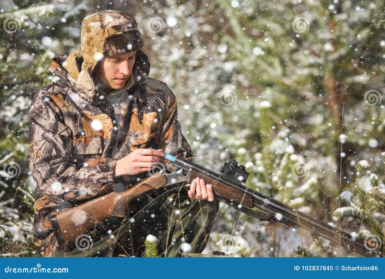 Hunter with a Backpack and a Hunting Gun in the Winter Forest. Stock ...