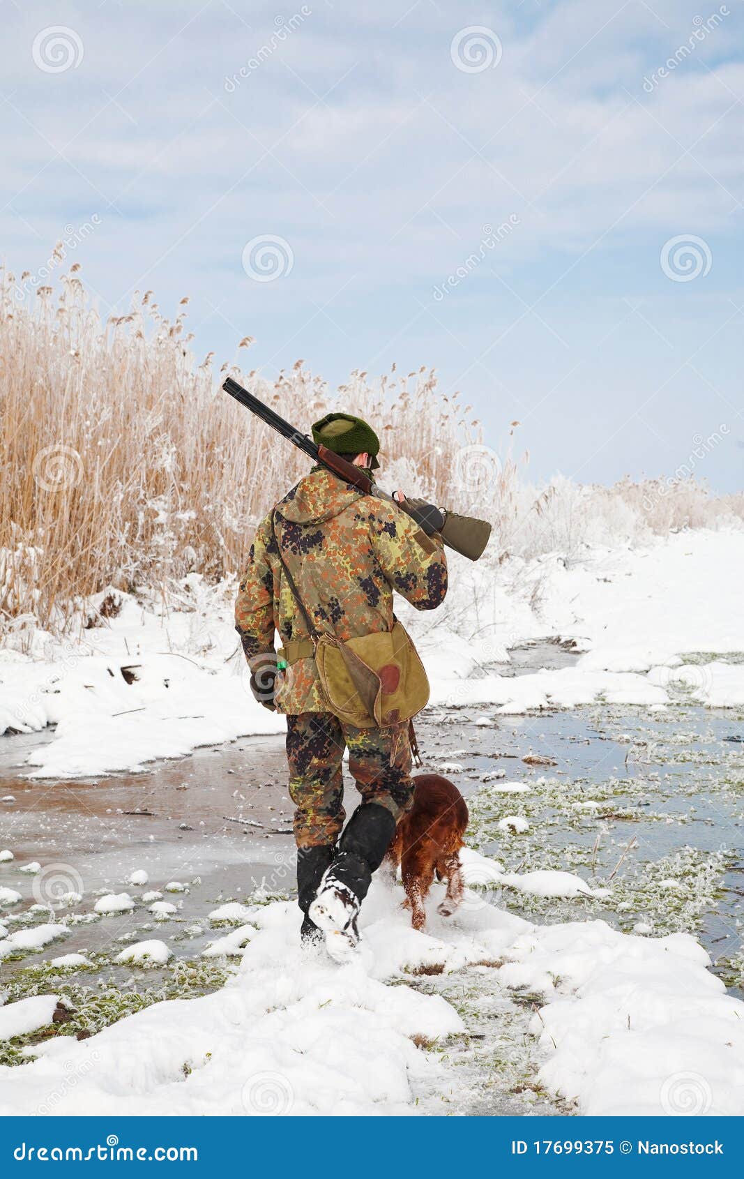 hunter with his hunting dog during a winter hunt