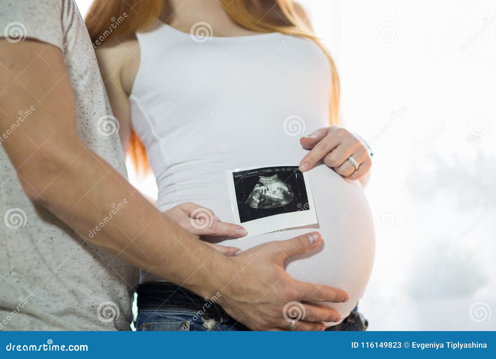 Husband and Pregnant Wife in a Room Stock Image pic picture