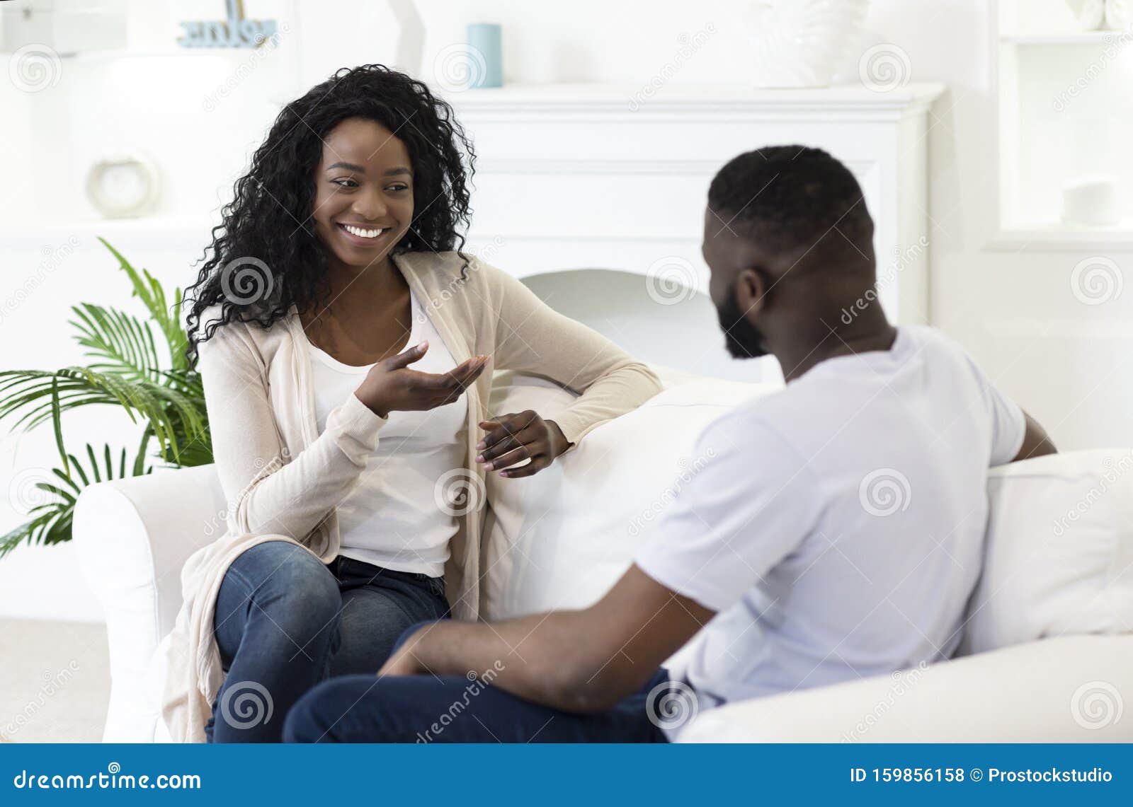 Husband and Wife Chatting Together in Living Room at Home Stoc pic photo