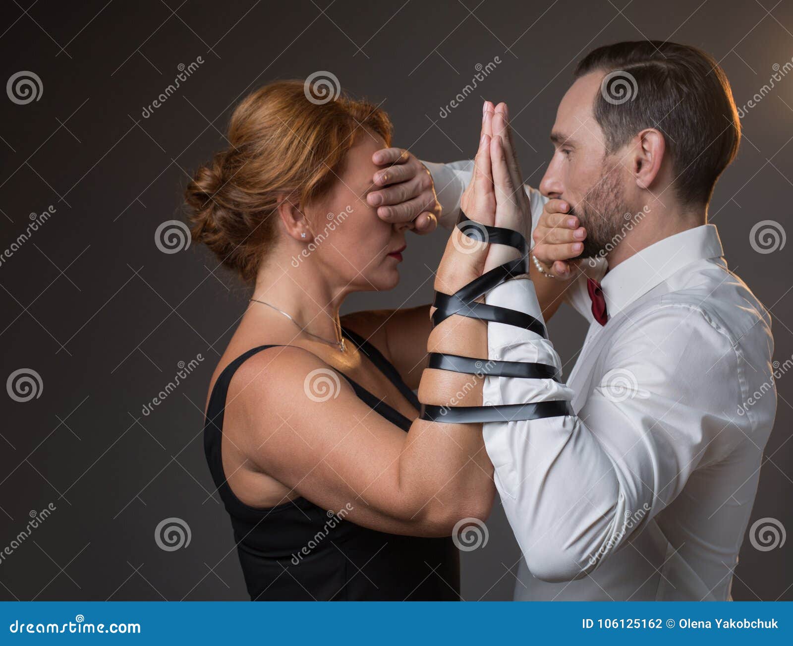 Husband and Wife Hands Tied by Tape Stock Photo