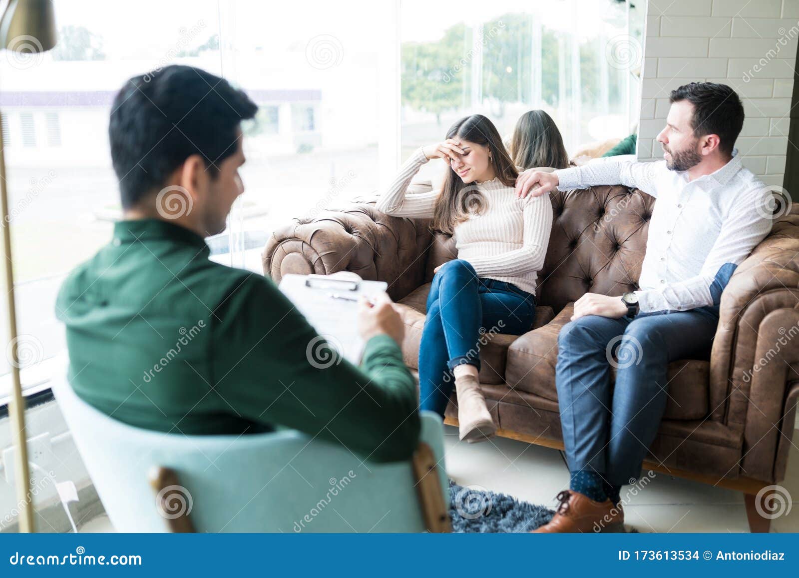 Husband And Wife Sharing Their Problems With Counselor Stock Phot