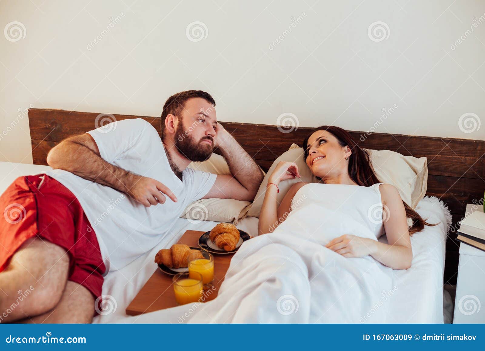 Husband And Wife Wake Up In The Morning In The Bedroom Weekend