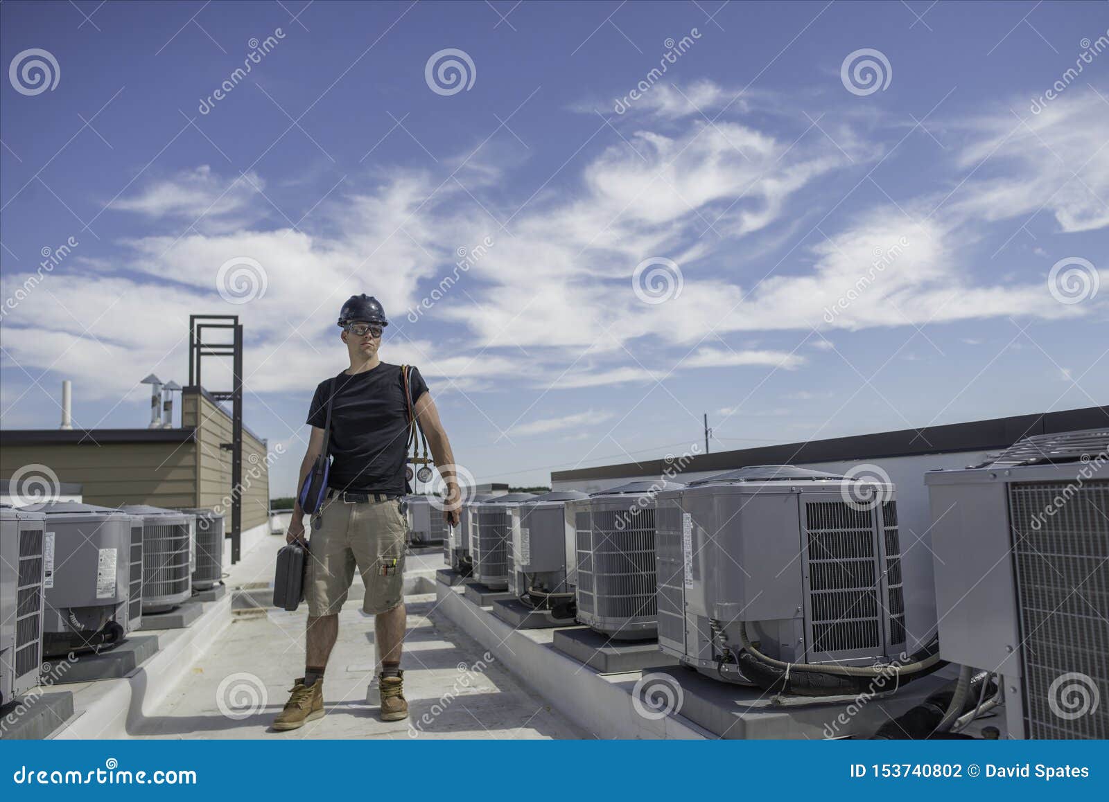 Hvac Tech Next To Condensers Stock Photo Image of outdoors, work