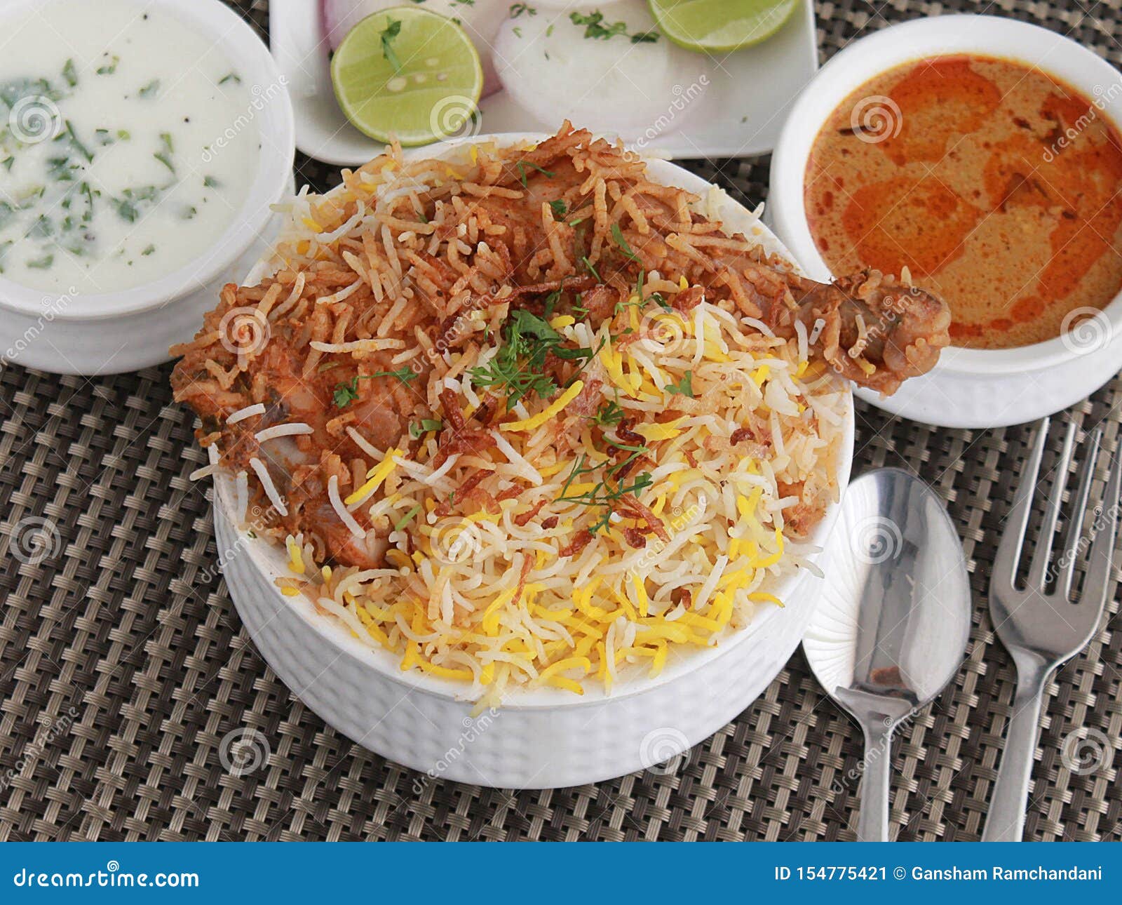 Hyderabad Chicken Dum Biryani with Korma, Curd Chutney Stock Image